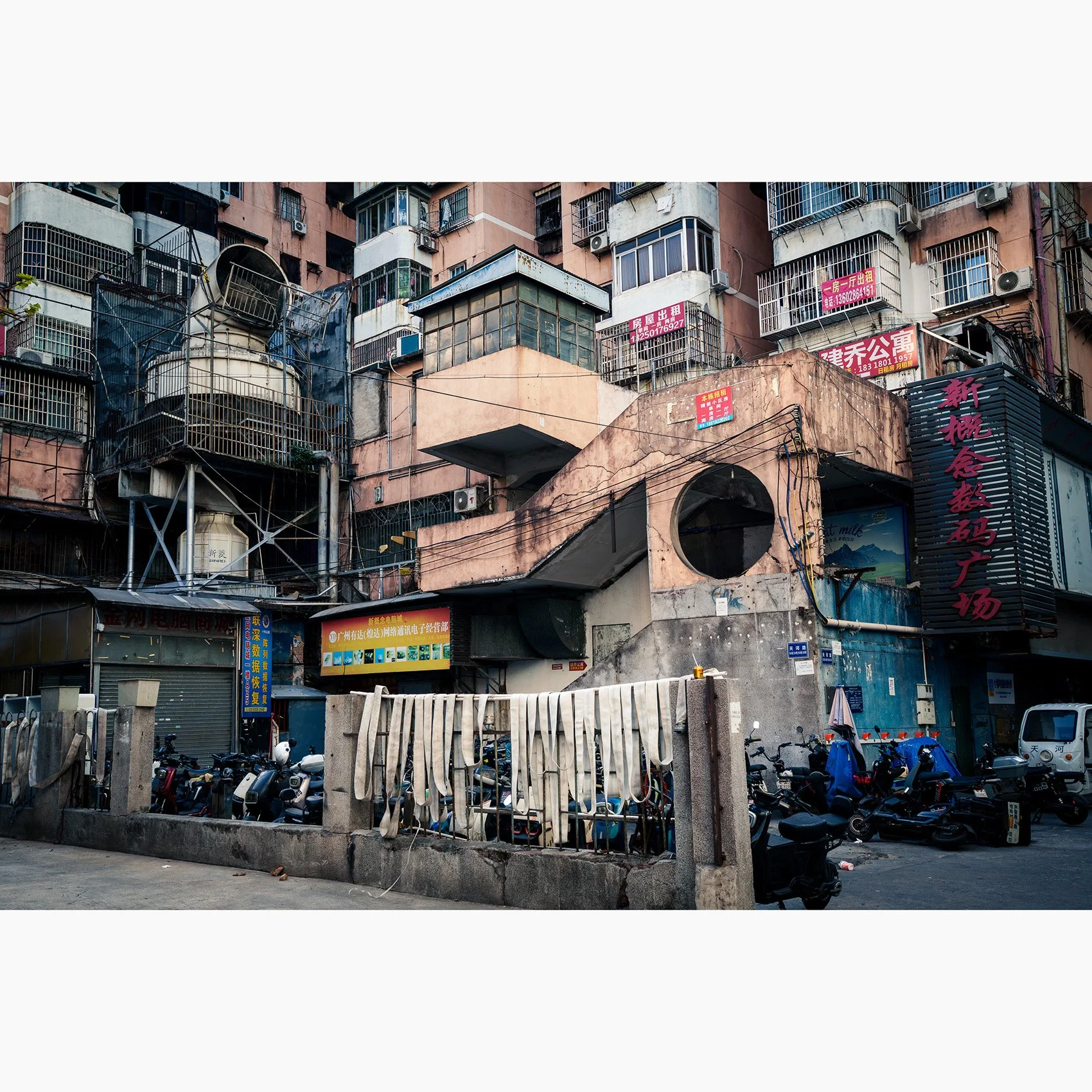 Fine art photograph of layered apartment buildings and ageing concrete architecture in Guangzhou, China.