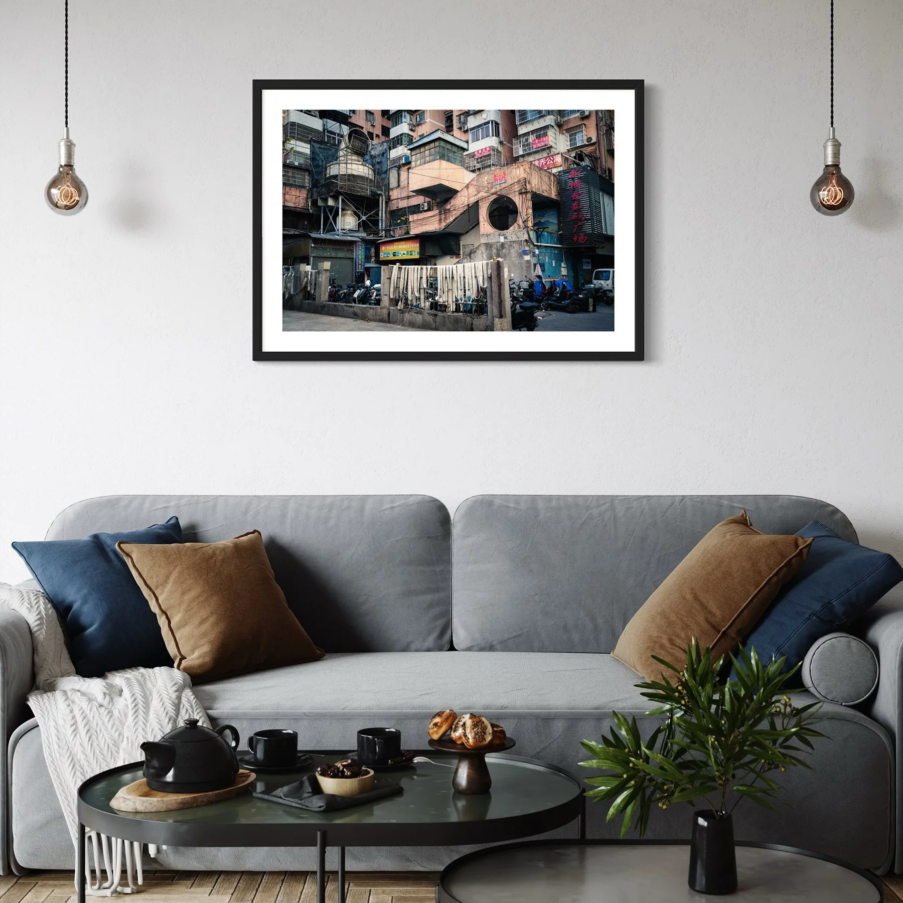 Framed Guangzhou architecture print above a grey sofa in a contemporary living room.