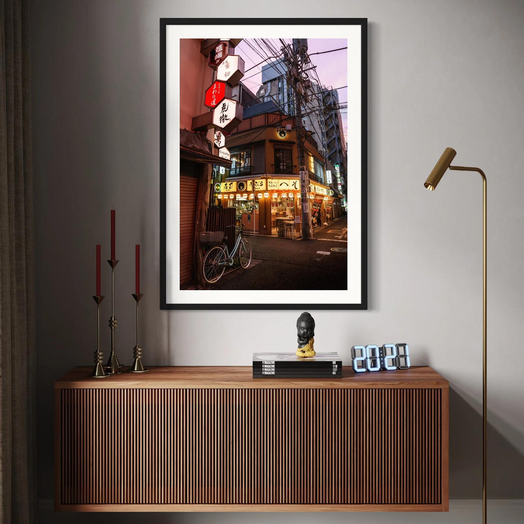 Urban Tokyo photography print in a black frame displayed above a timber sideboard in a contemporary interior with warm lighting.