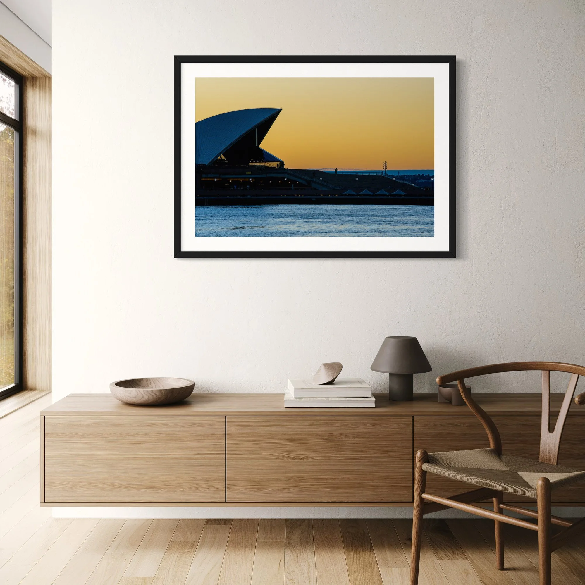 Opera House Sunrise fine art photography print displayed above a timber sideboard in a contemporary living room.