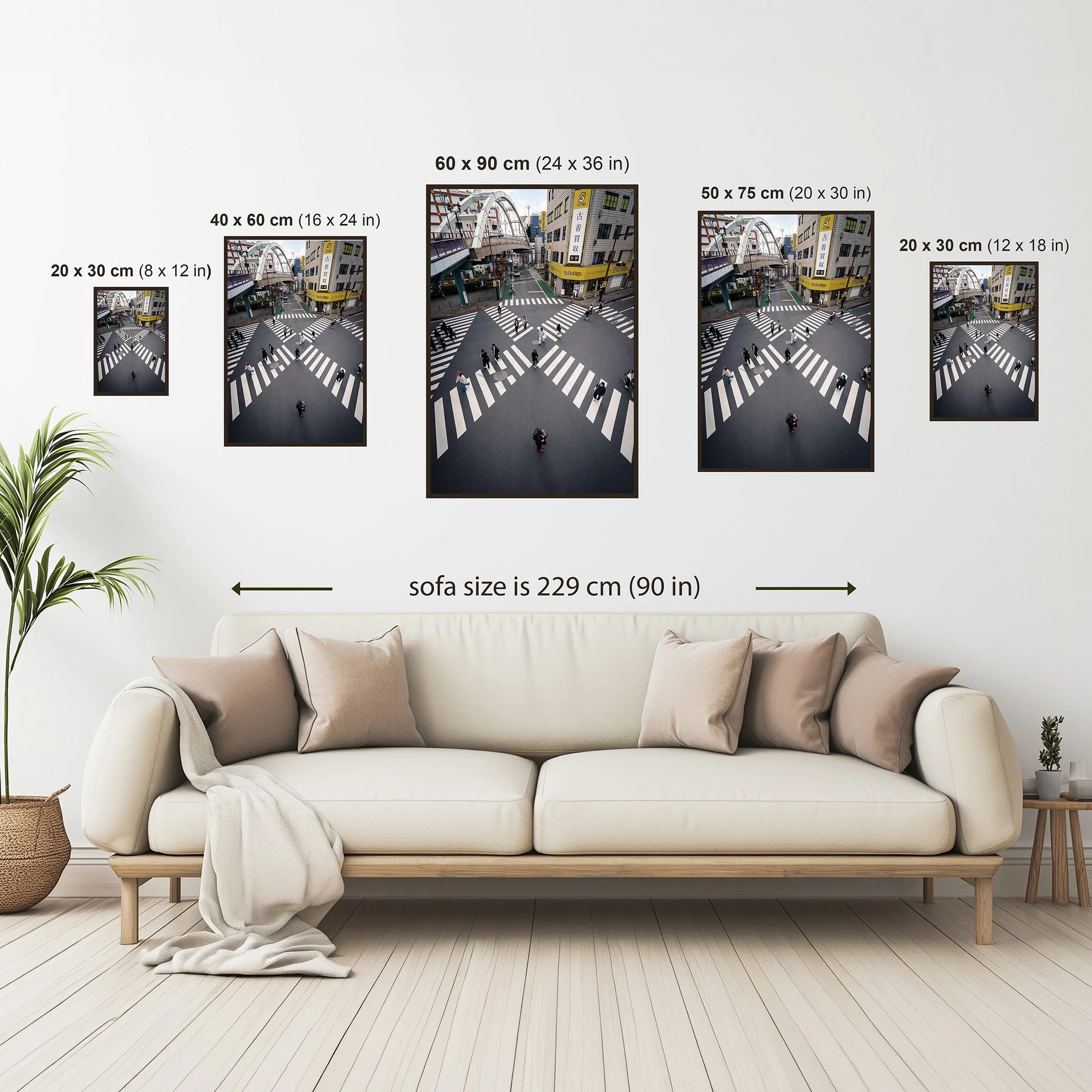 Size comparison guide showing available dimensions for a portrait urban photography print displayed above a sofa for scale reference.