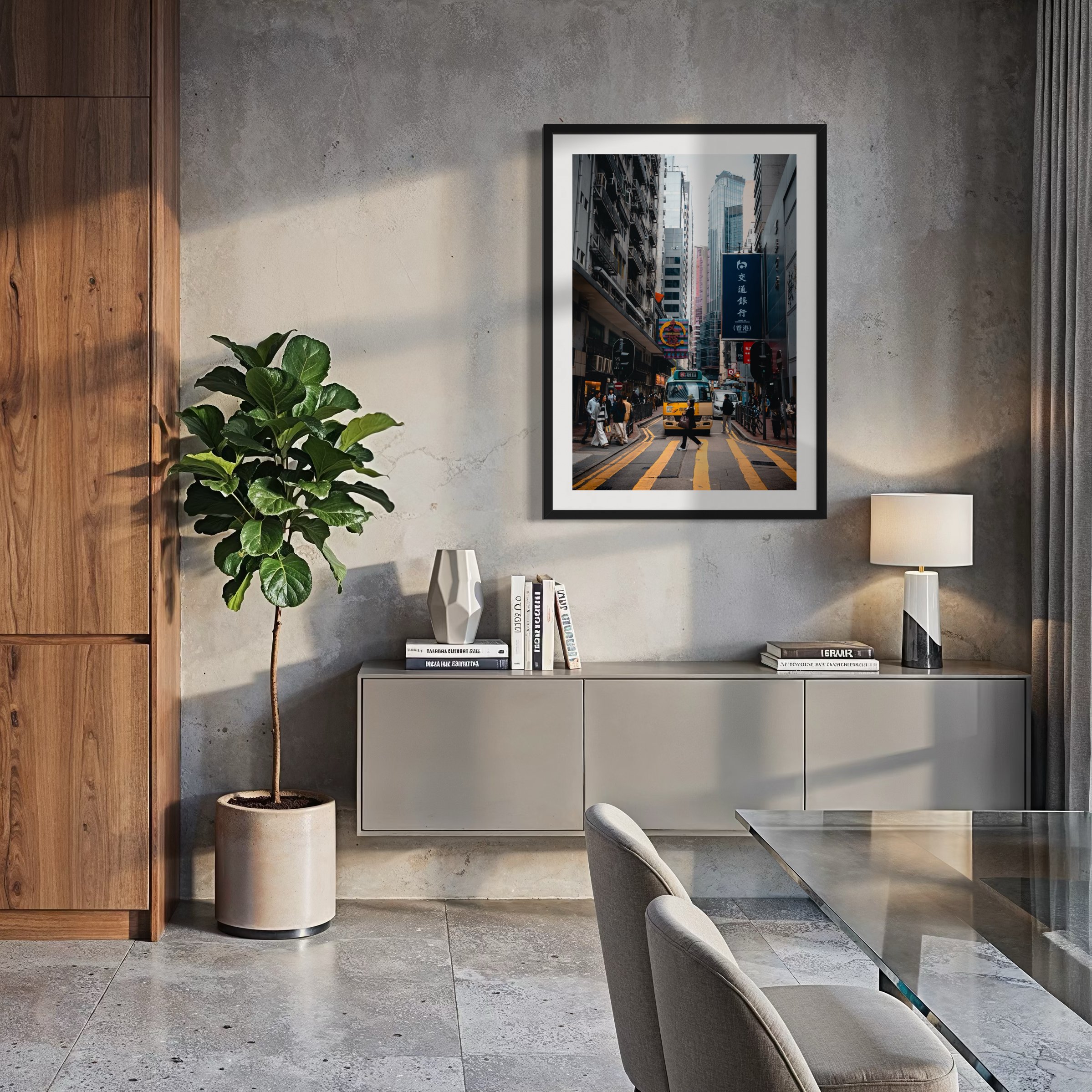Contemporary dining room with concrete walls and framed Hong Kong city photography print featuring layered architecture, pedestrians and a yellow minibus.