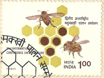 A postage stamp from India valued at 100 paise featuring two bees around a honeycomb pattern and Hindi text.