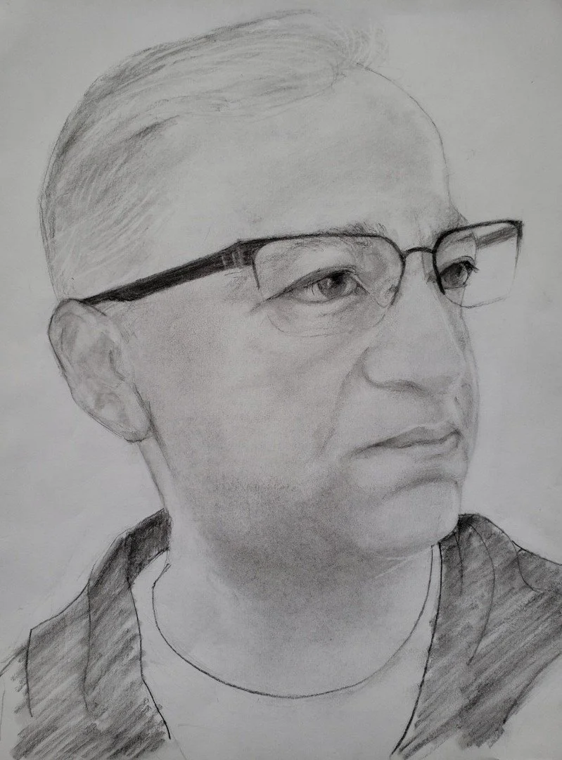 A detailed pencil sketch of a middle-aged man with glasses, short hair, and a serious expression, facing slightly to the right.