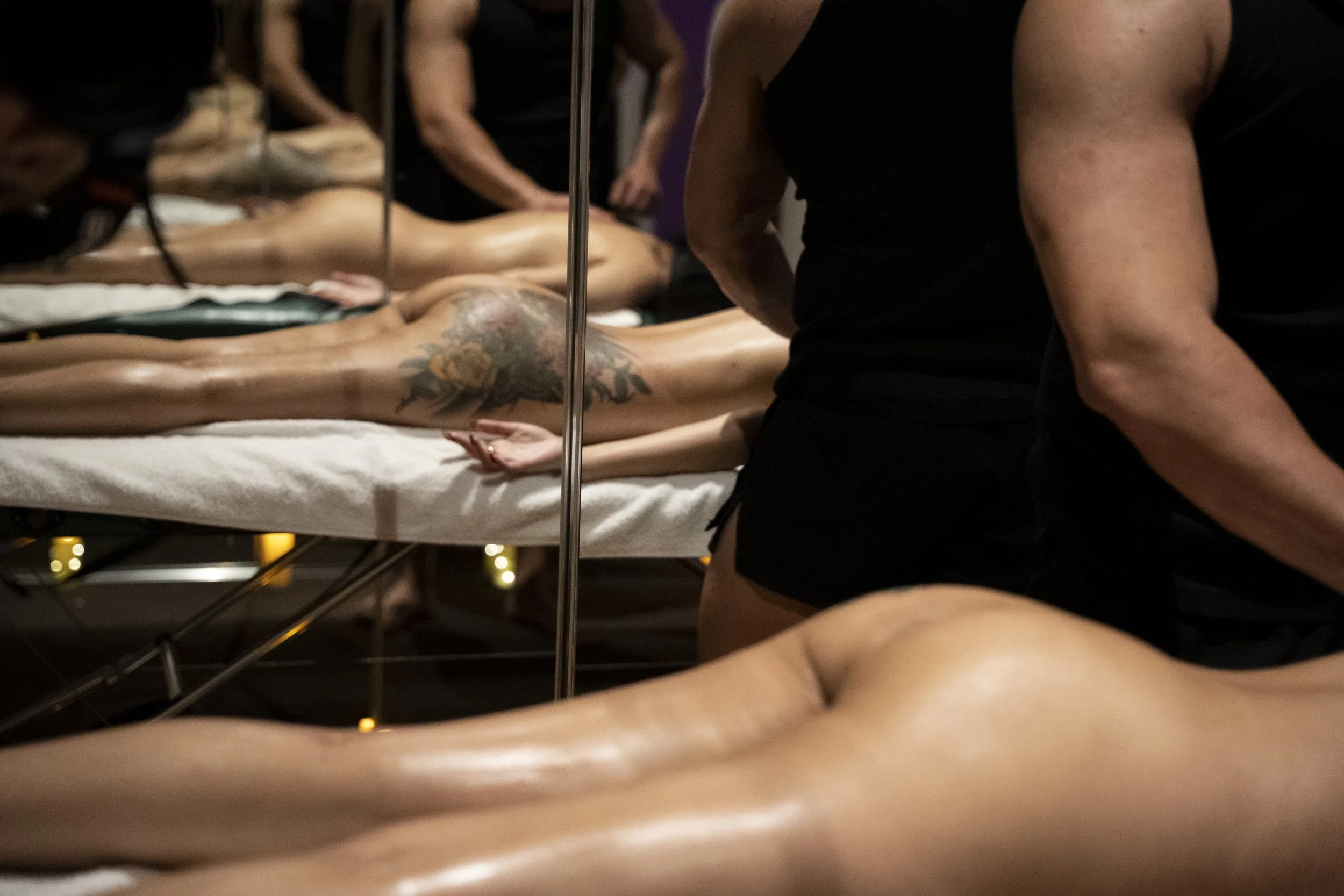 woman receiving an erotic massage from a handsome muscular masseuse