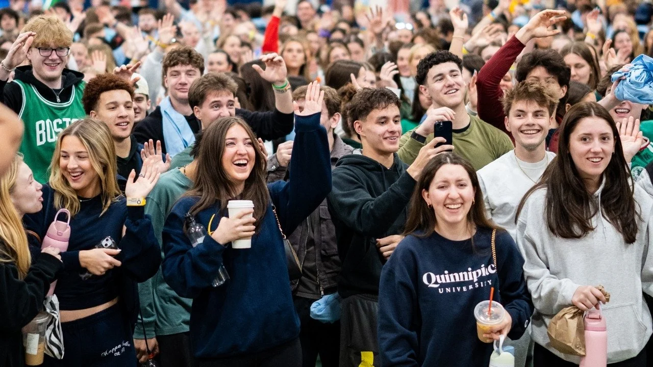 Crowd of students cheering during QTHON