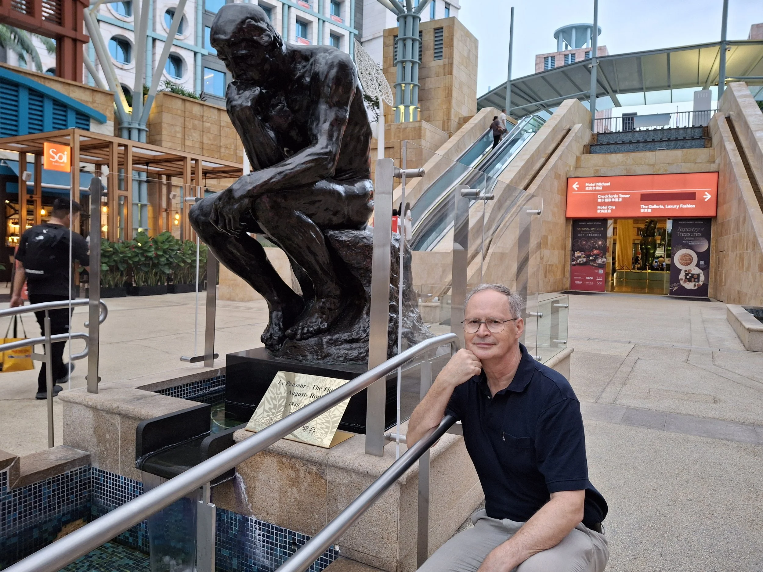 Dr M Rushton beside Rodin sculpture 'The Thinker' at Resorts World Sentosa, Singapore.