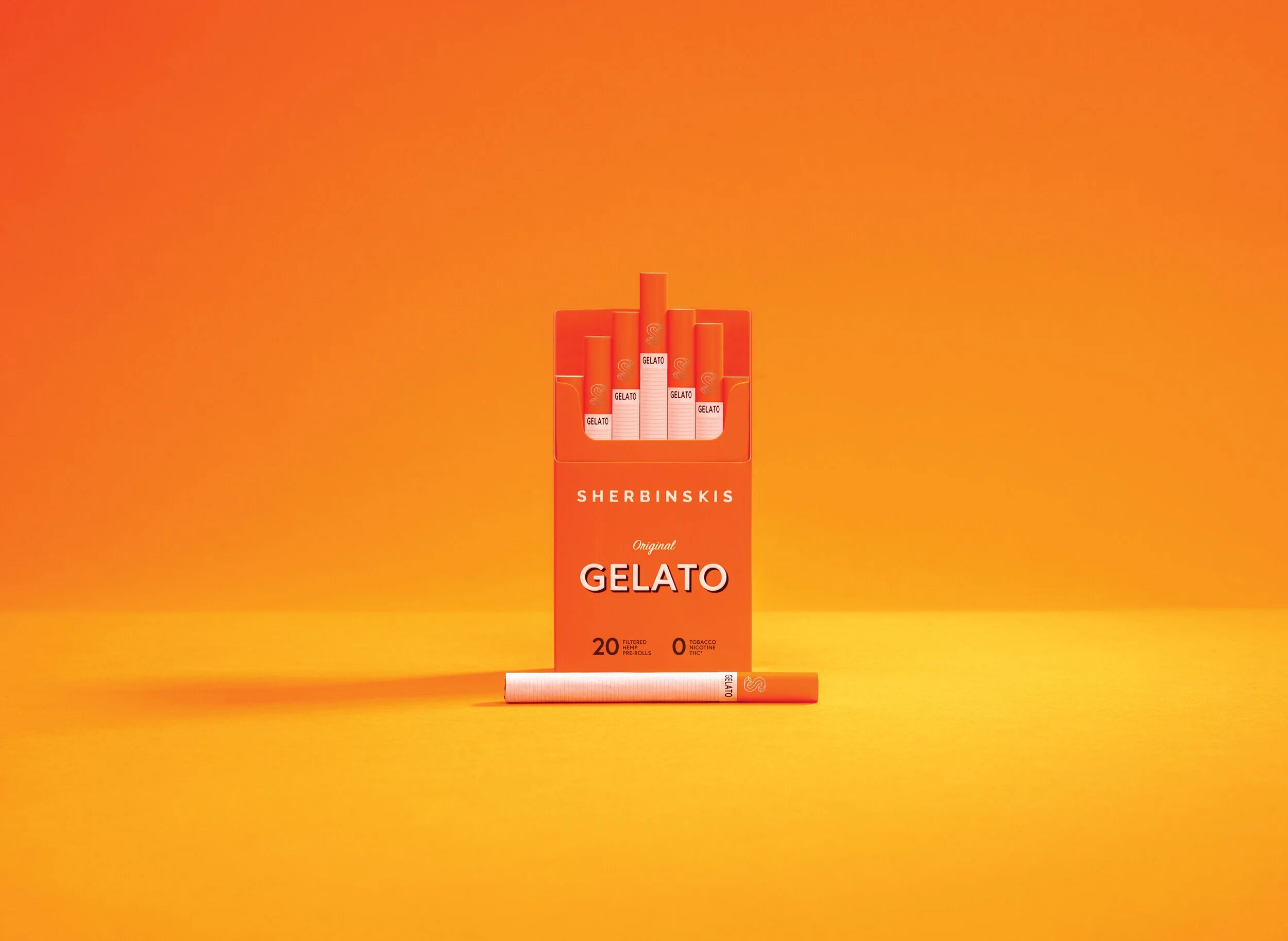 A pack of Sherbinski's Gelato pre-rolled hemp cigarettes with an outer orange box and a single cigarette lying in front, set against a yellow background.