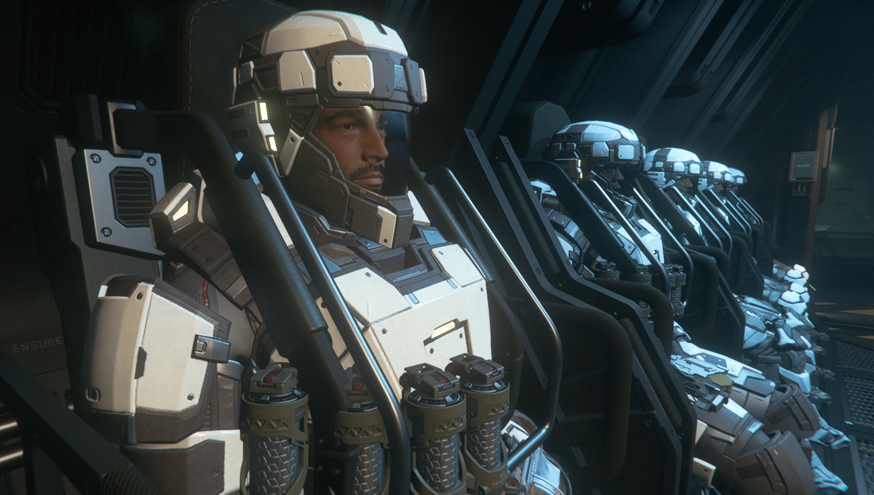 A row of astronauts in high-tech space suits seated inside a spaceship cockpit.