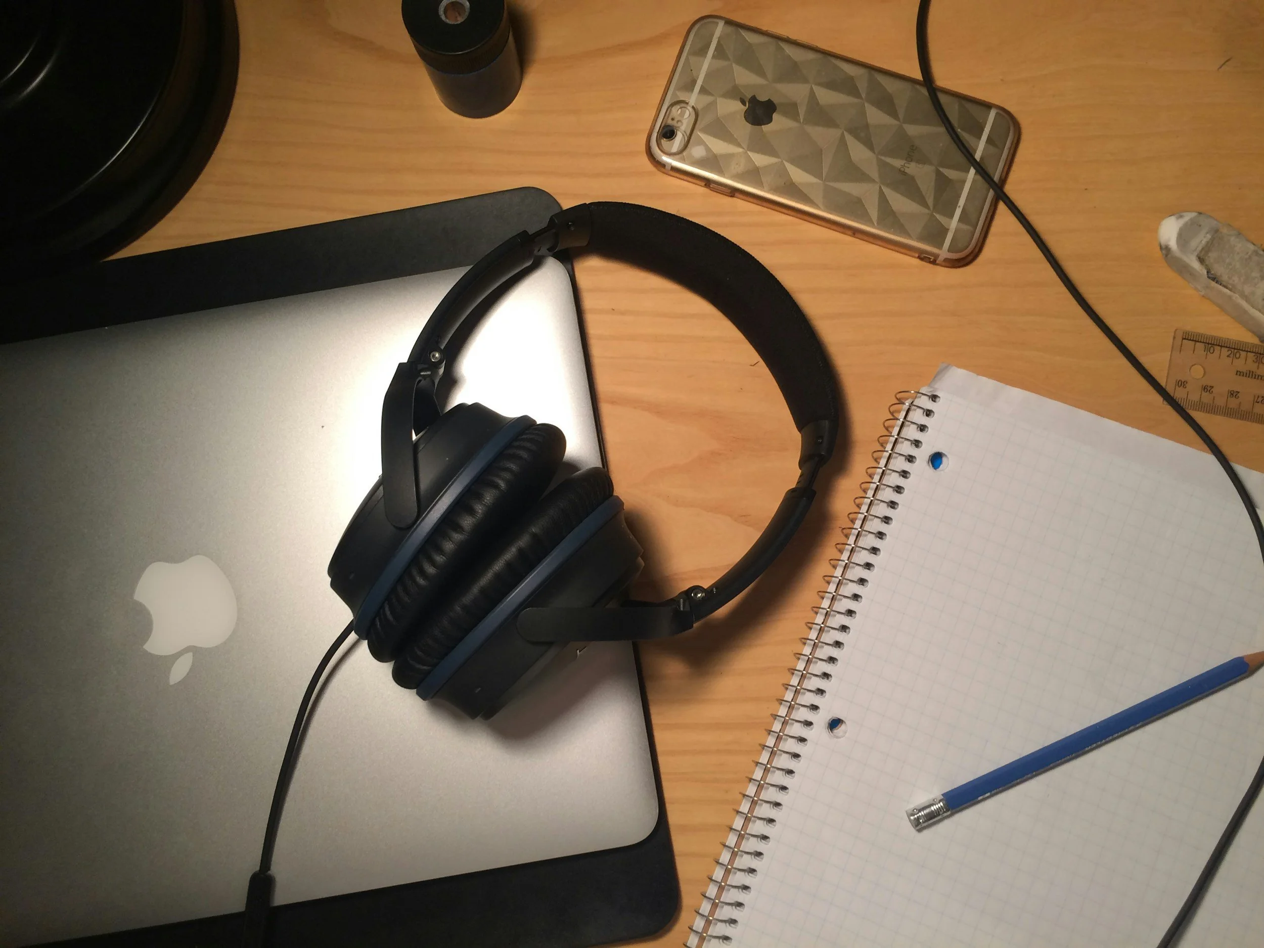 Noise-cancelling headphones, fidget toy, and tea flat lay.