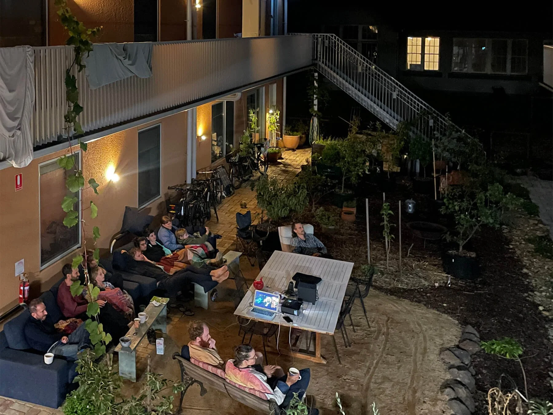 Residents watching a film screening in the courtyard at Victoria Street Collective.