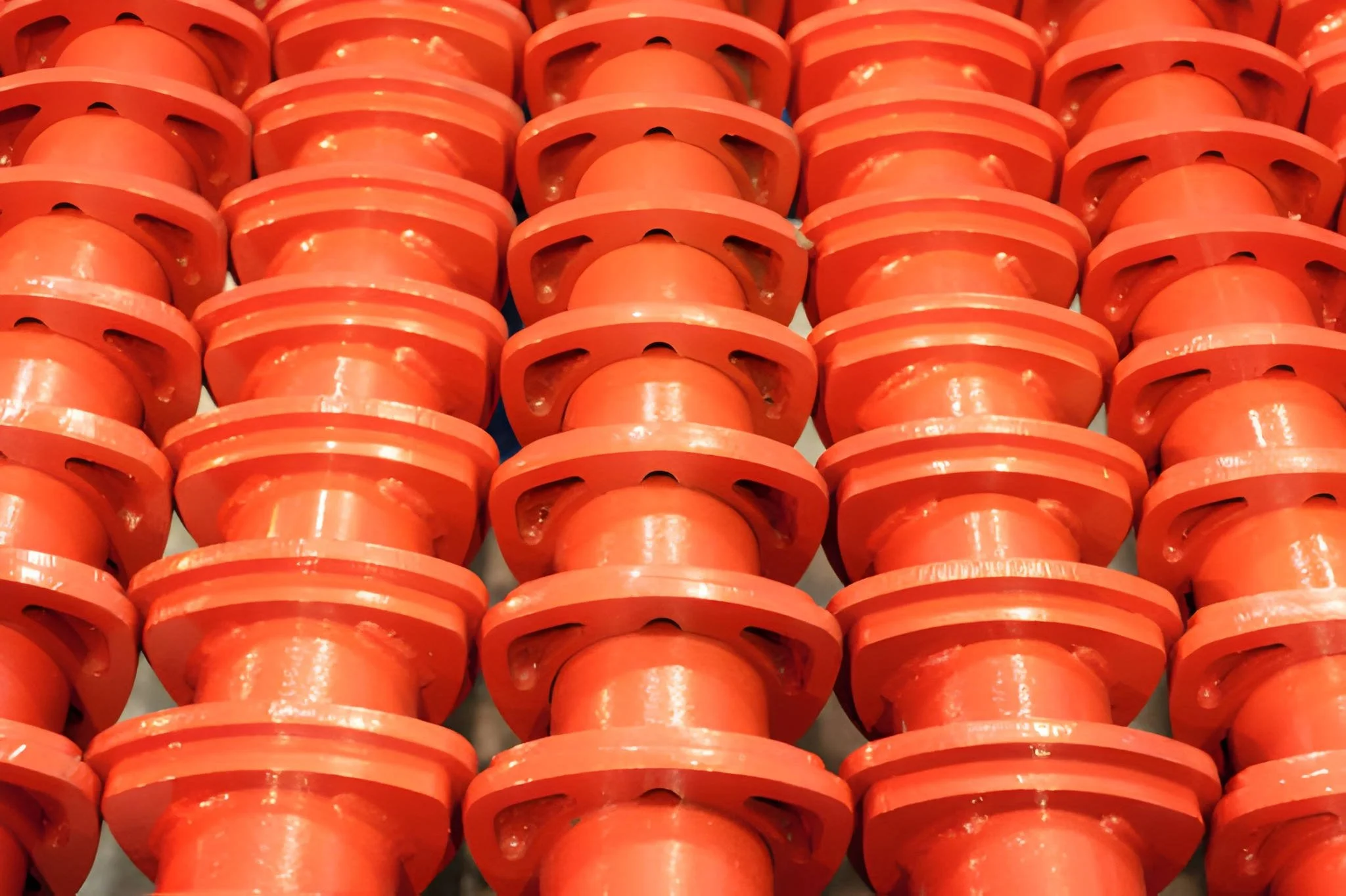 Close-up view of multiple orange plastic spacers arranged in rows.