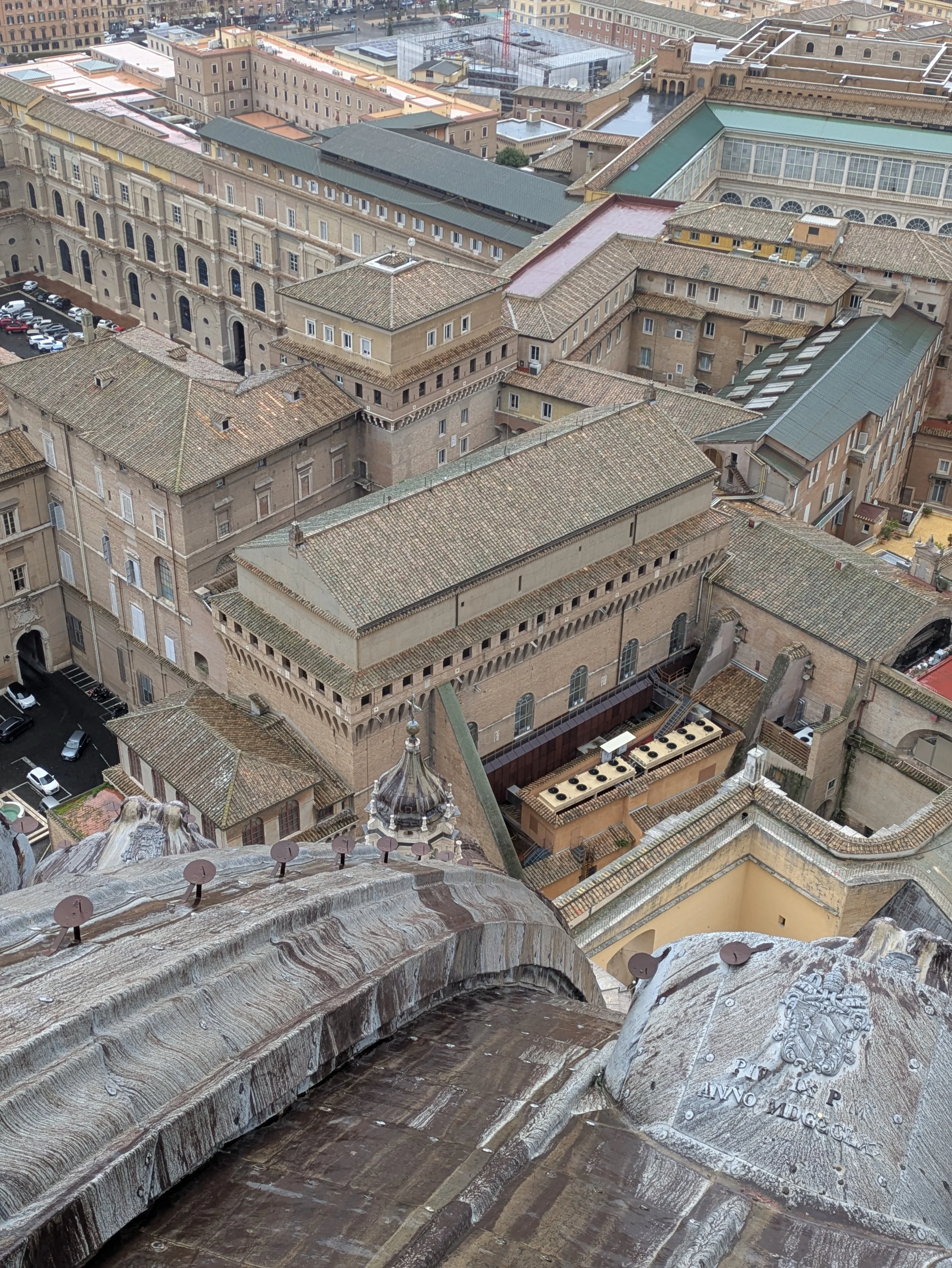 A view from the lantern, note the round metal candle holders lining the dome, with the roof of the Sistine Chapel center frame, original photo