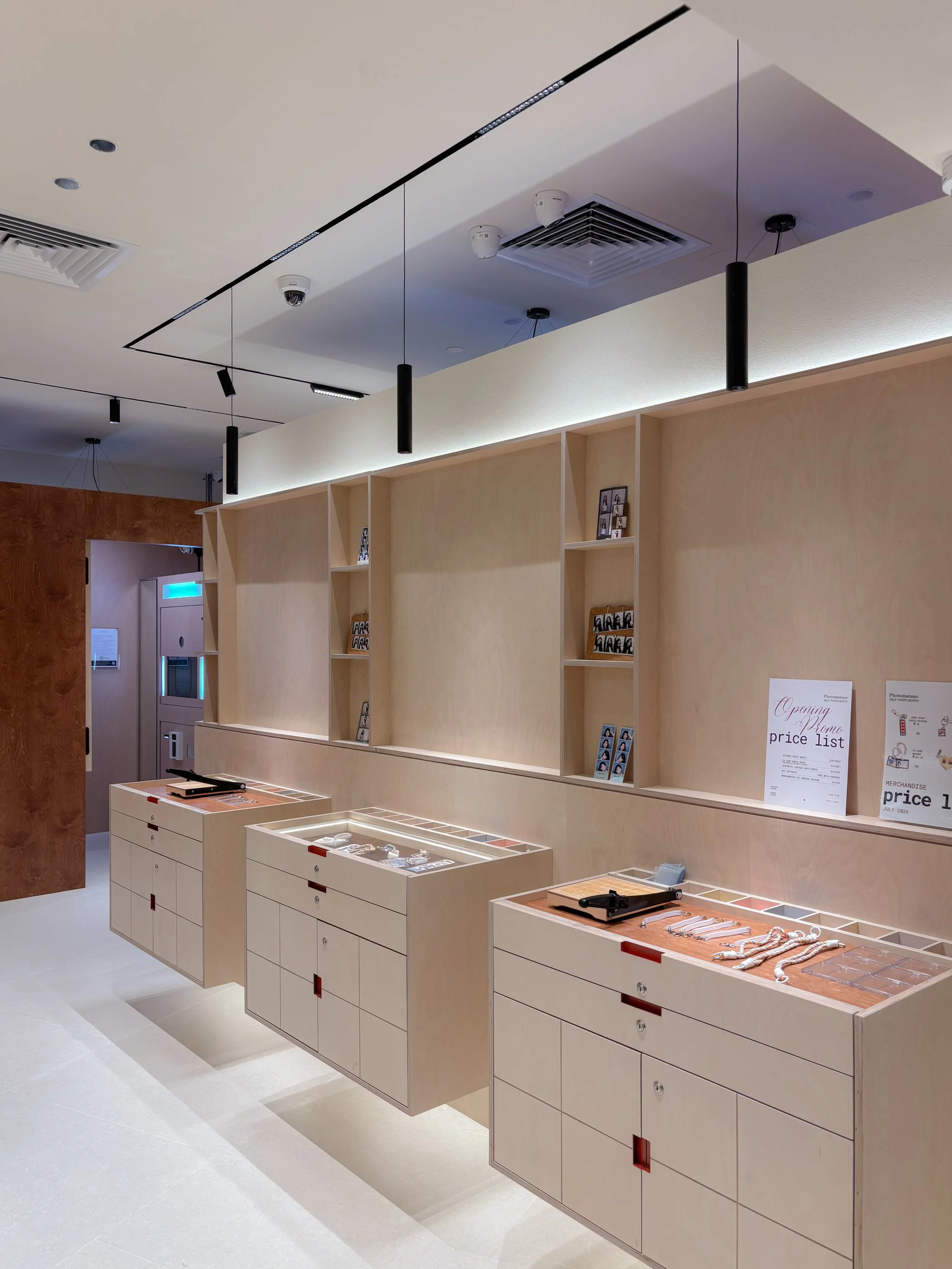 Interior of a jewelry or accessory store with display counters and shelves, featuring jewelry and accessories, with signs displaying price lists and promotional information.