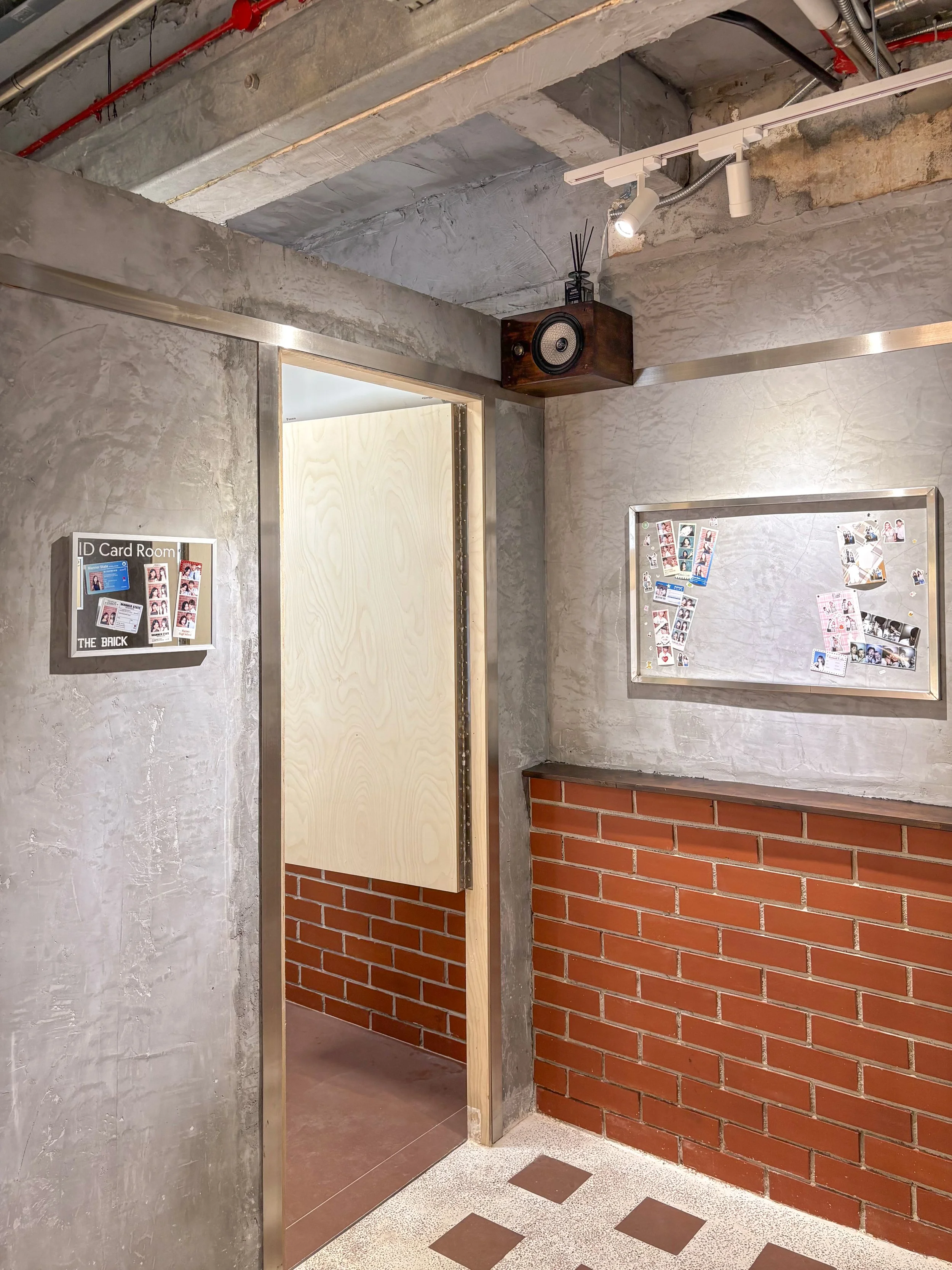 Interior of Photomanner The Brick House showcasing industrial-style building with exposed concrete, brick wall, and metal framing.