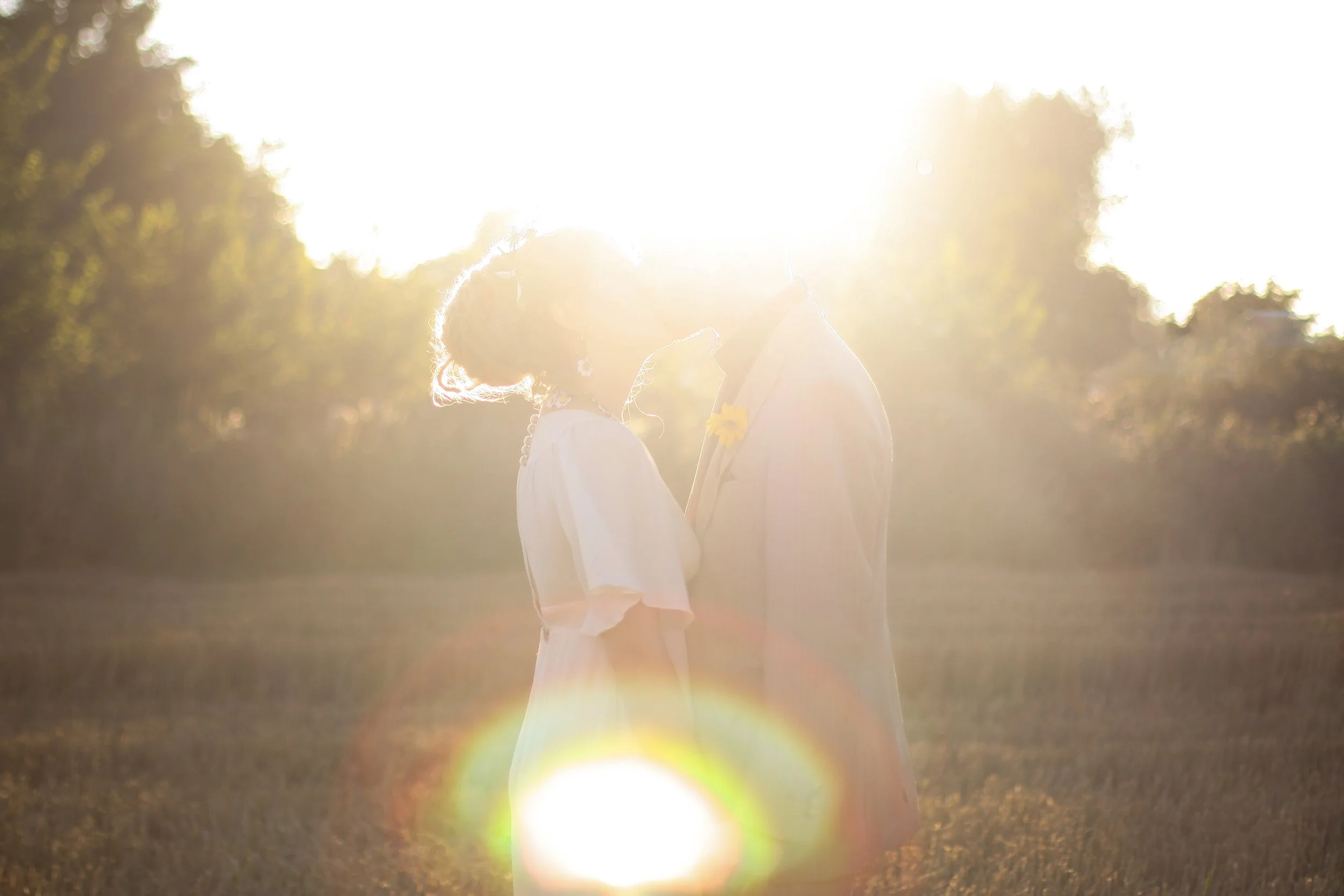 Happy couple kiss in outdoor ceremony