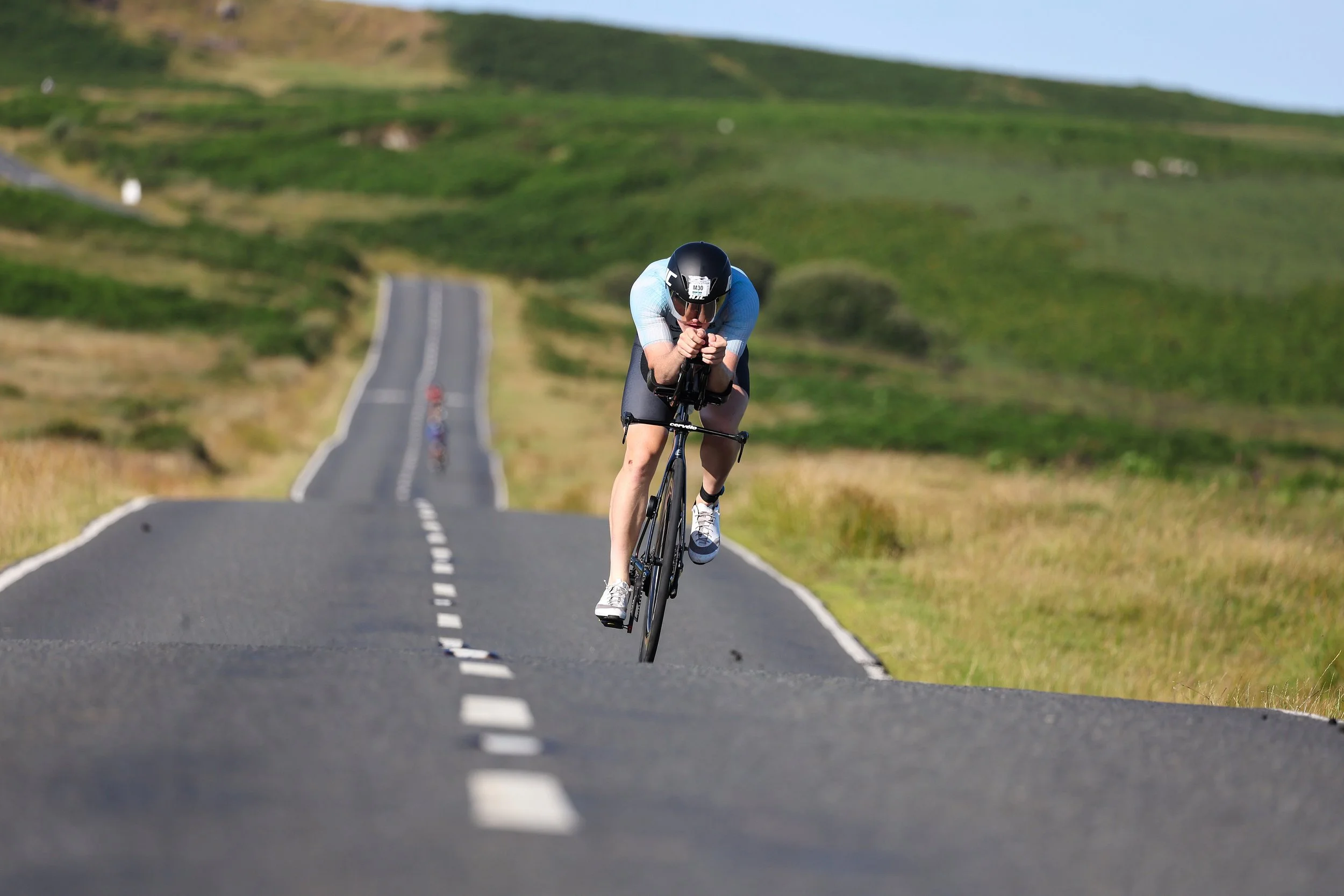 Cyclist on TT bike, during a triathlon race. Very well respected Swansea 70.3.