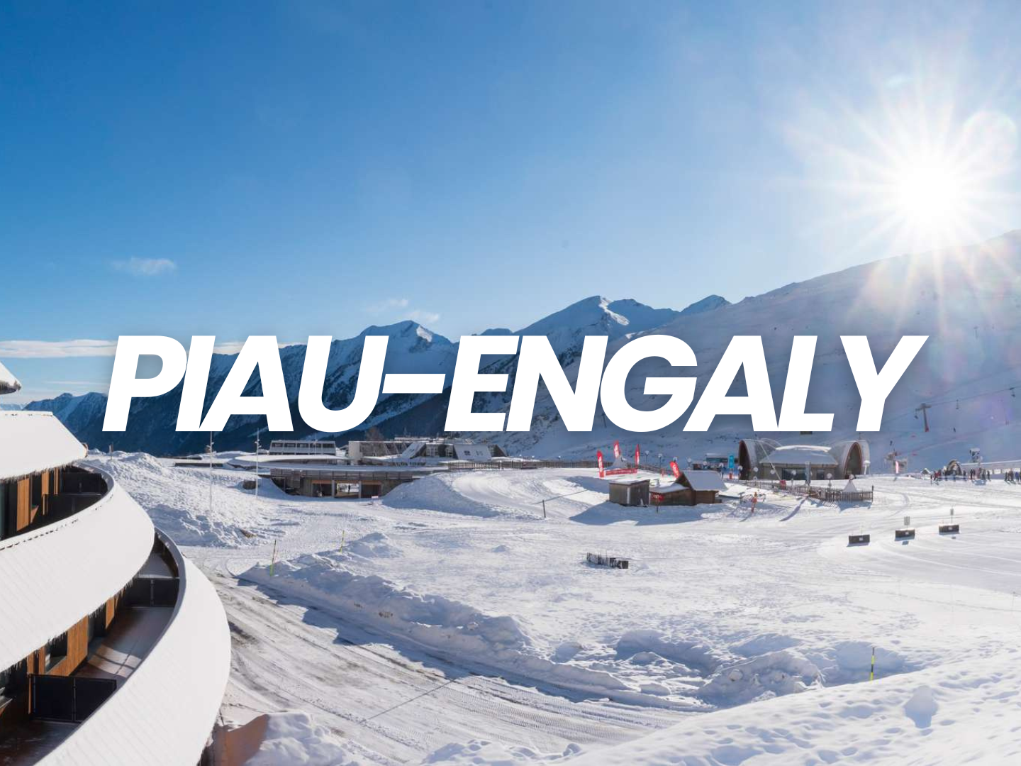 Station de ski en montagne enneigée avec bâtiments modernes et soleil brillant dans le ciel bleu au sommet de la station à Piau-Engaly.