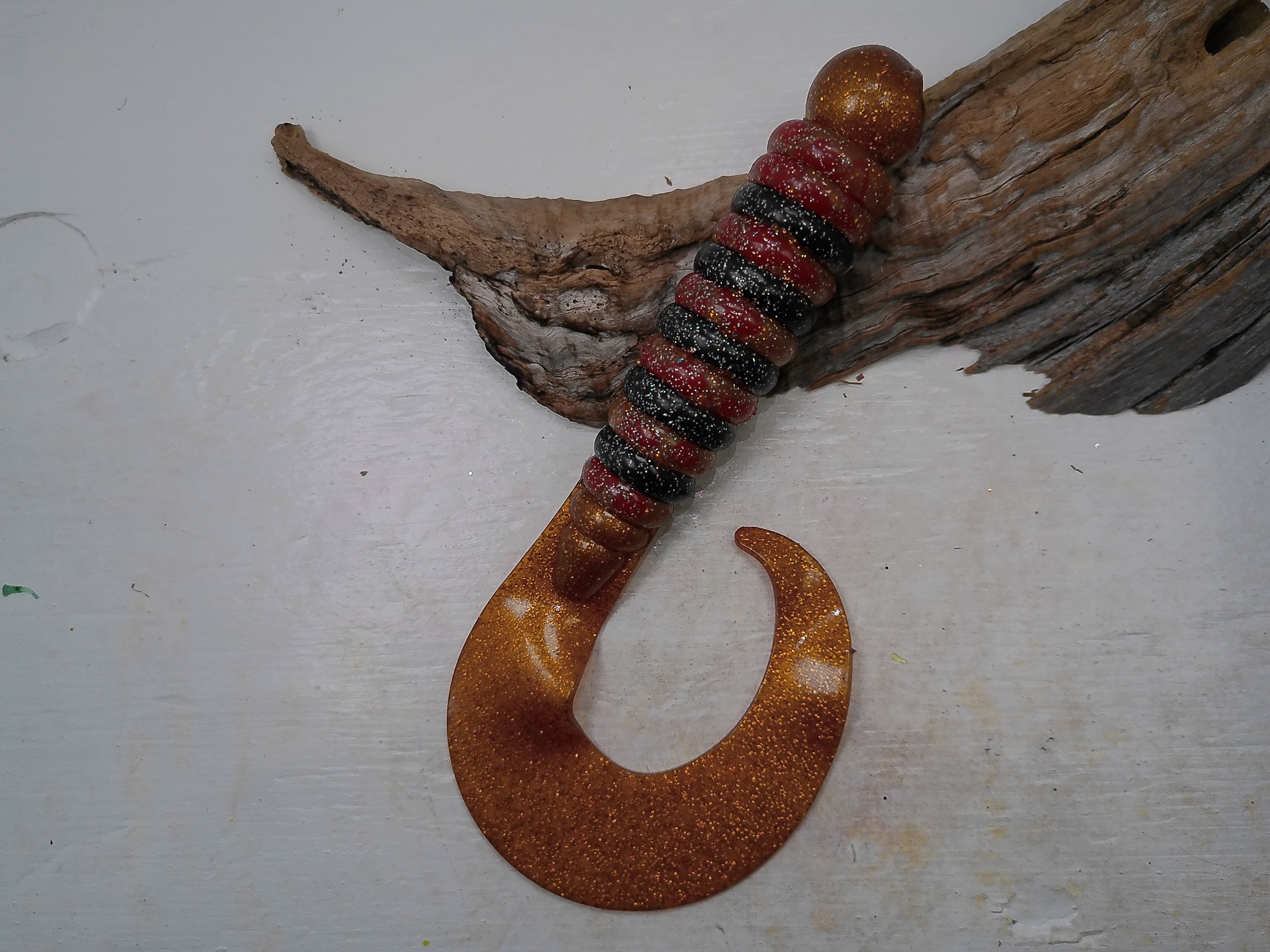 curly-tail-grub-fishing-lure-black-red-glitter-body-amber-gold-tail