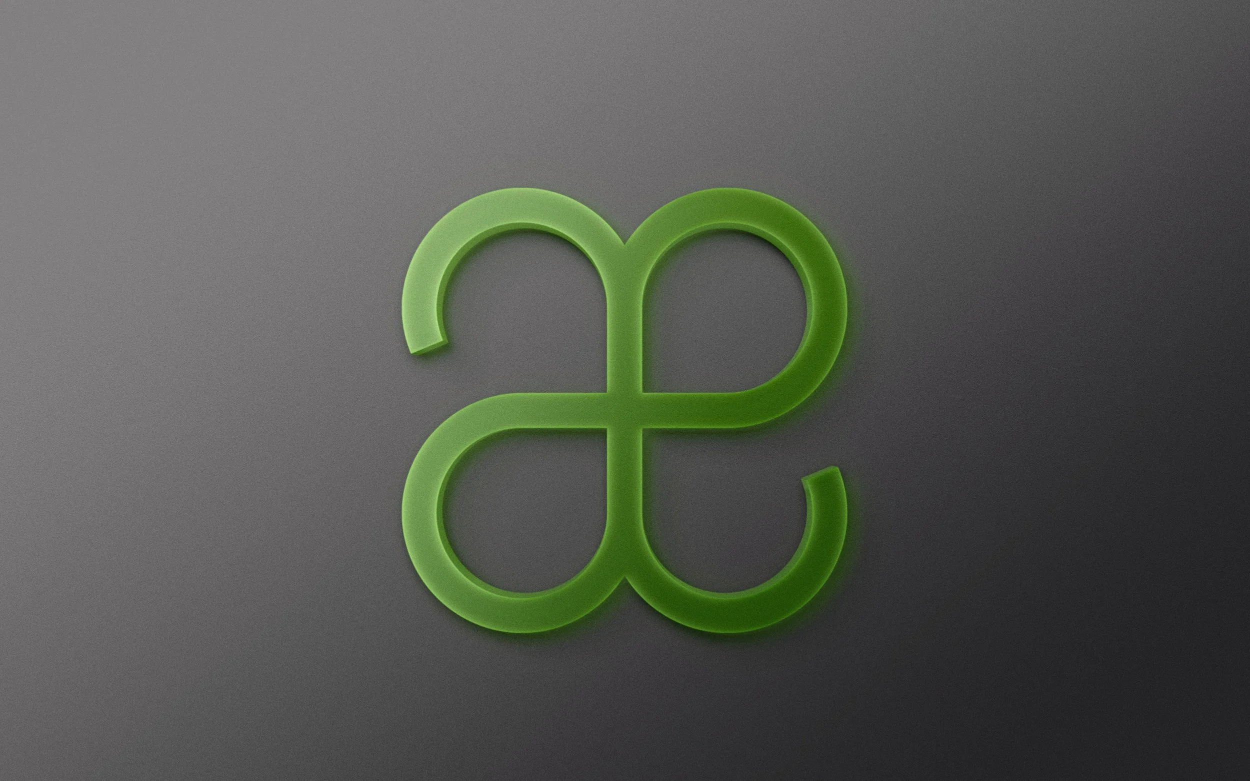 Green abstract geometric shape on dark gray background.