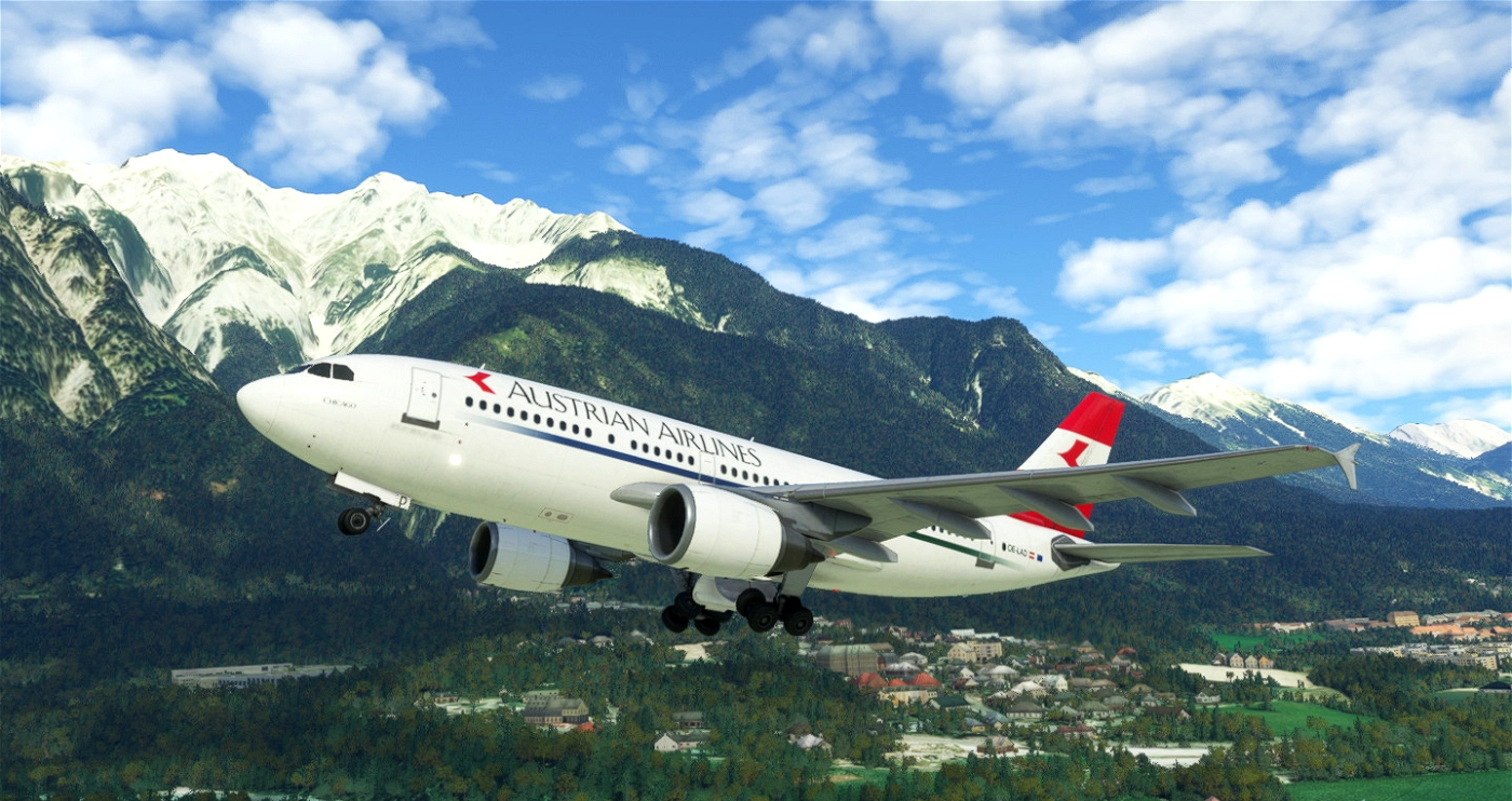 An airplane with Austrian Airlines livery flying over a mountainous landscape with snow-capped peaks and a small town below.