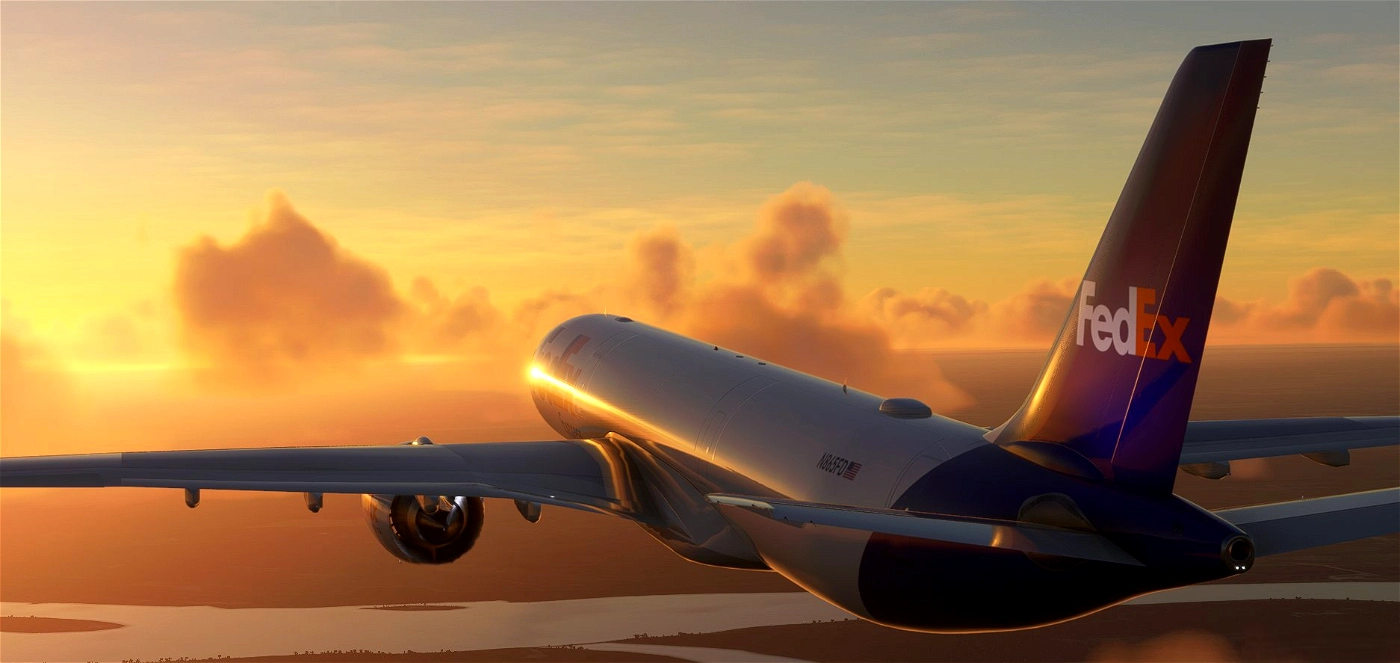 FedEx delivery airplane flying at sunset over a river.