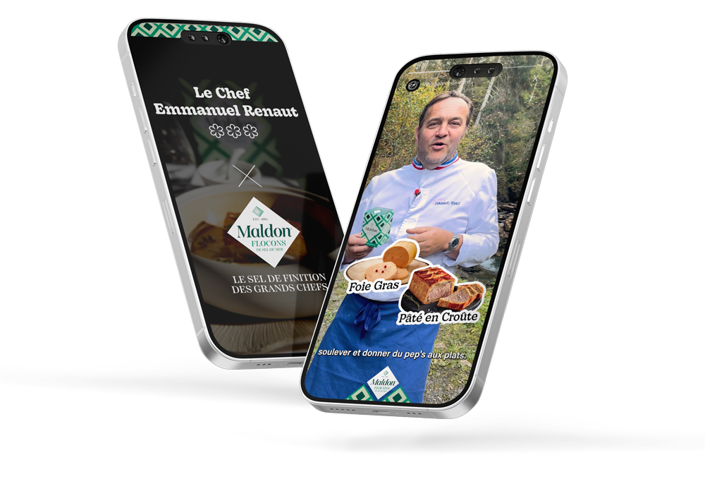 Deux téléphones portables affichant une publicité pour Maldon Flocons, le Chef Emmanuel Renaut, en tenue de cuisine avec des plats en gros plan, dont du foie gras et du pâté en croûte, lors d'un interview en nature