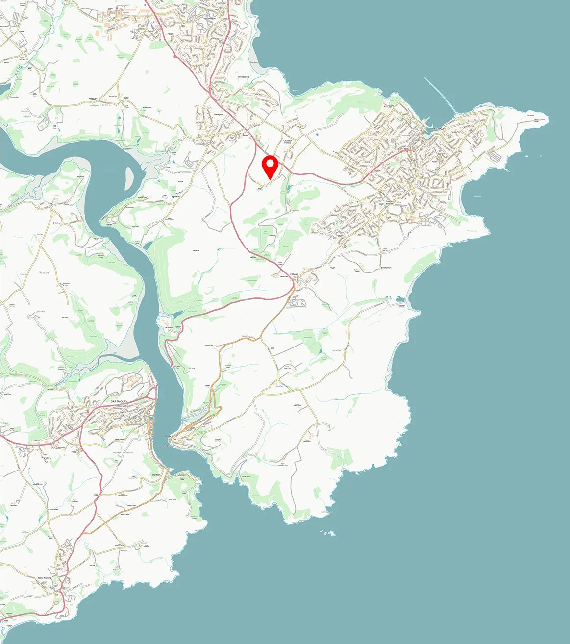 Map of a coastal area with roads, waterways, green spaces, and a red location marker near the center.