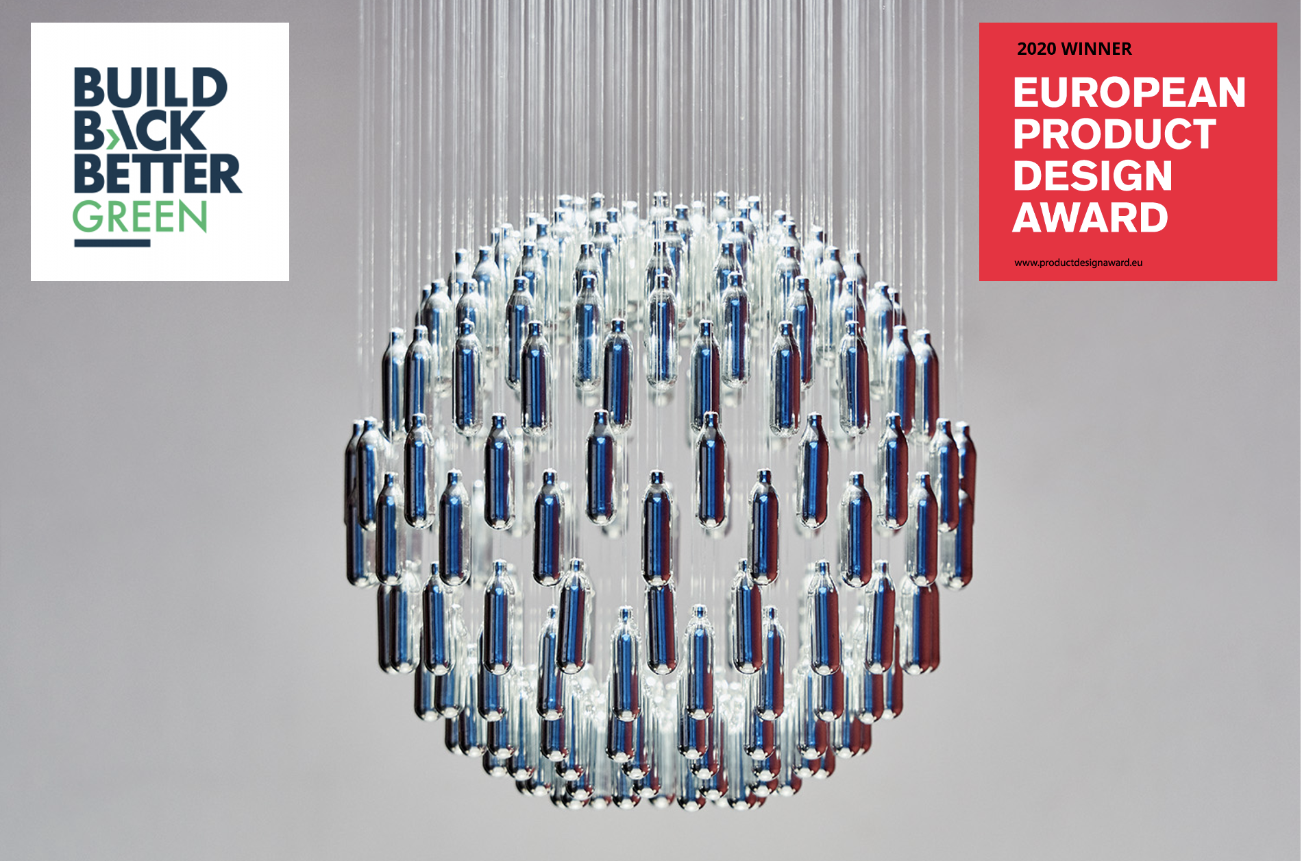 Close up of the award winning NOS Sphere chandelier made from discarded nitrous oxide canisters, foraged in London. Shown against a grey background with two award logos