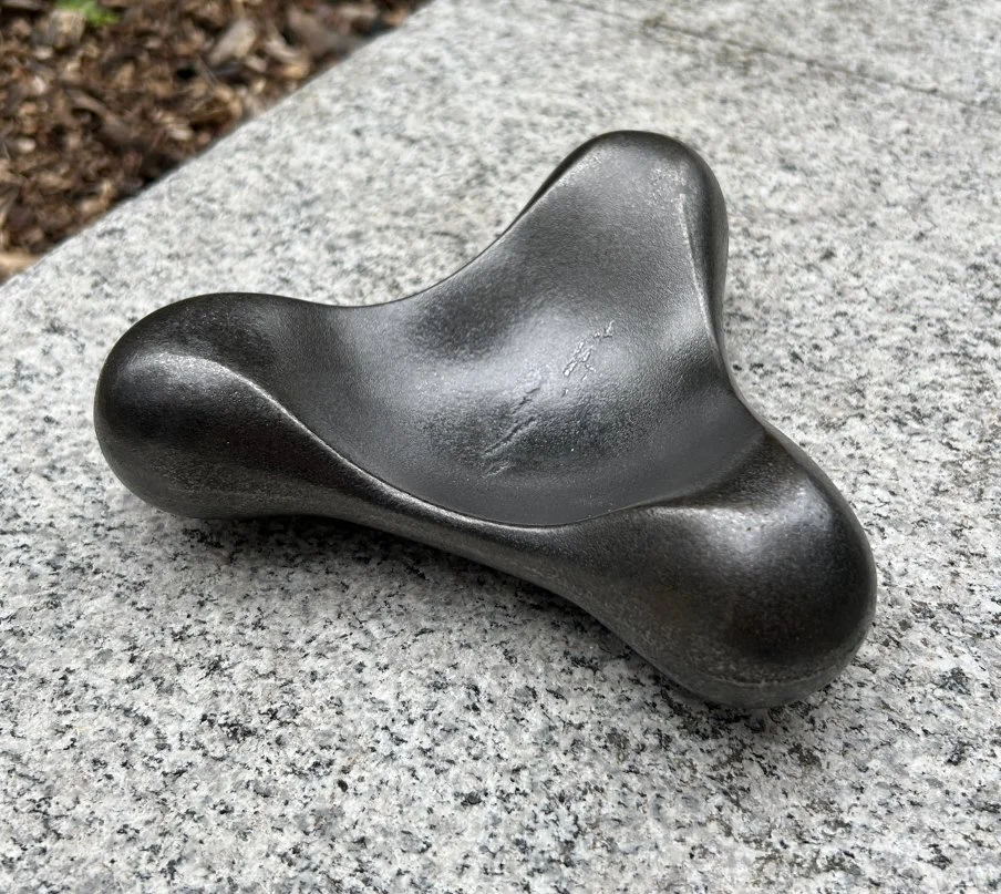 Lone Star, a black decorative dish made from blacked cast iron, upon a grey granite surface outside.