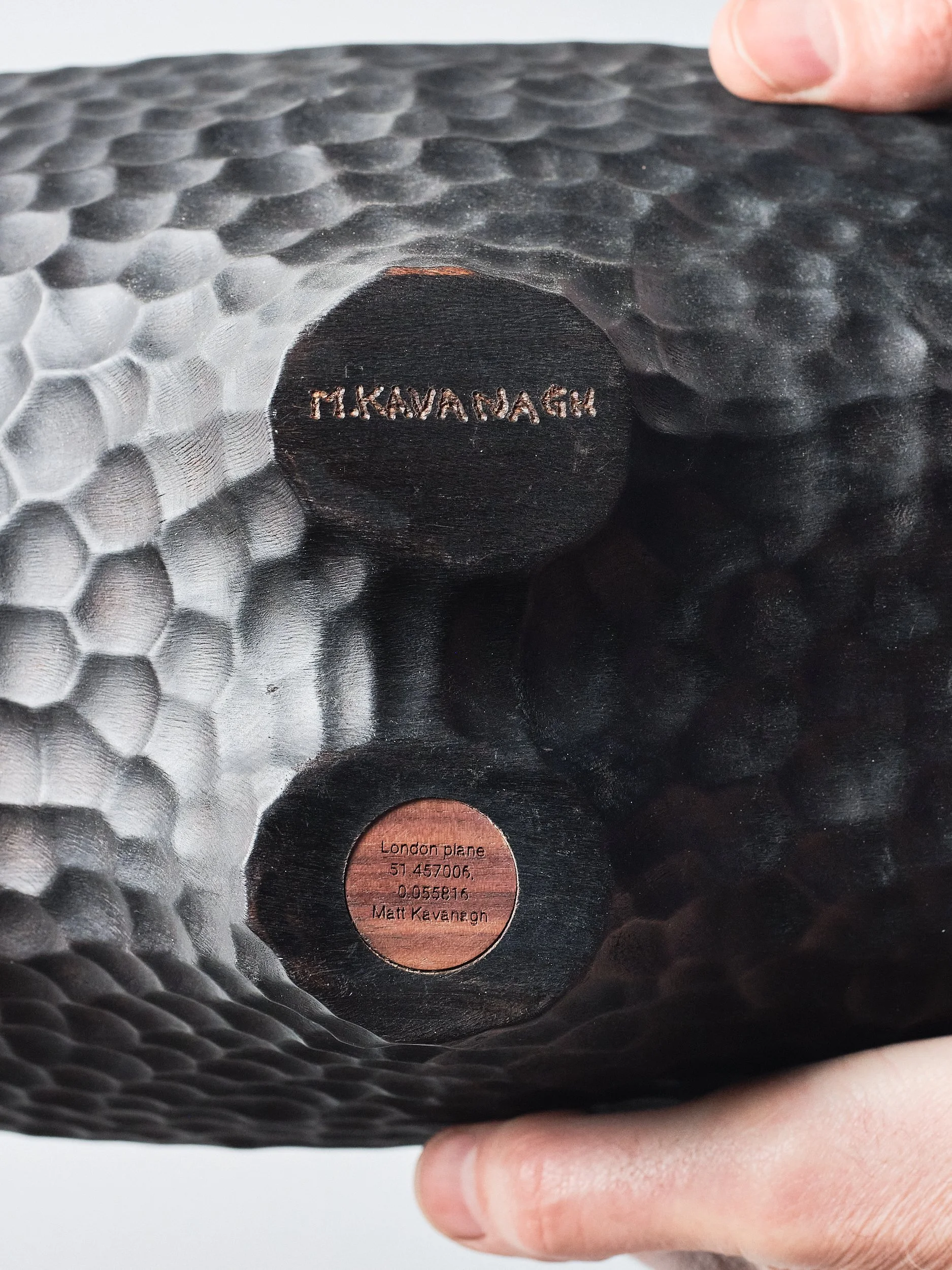 Close up view of the underside of the London Plane long bowl showing engraved coordinates of the tree location and artists signature.