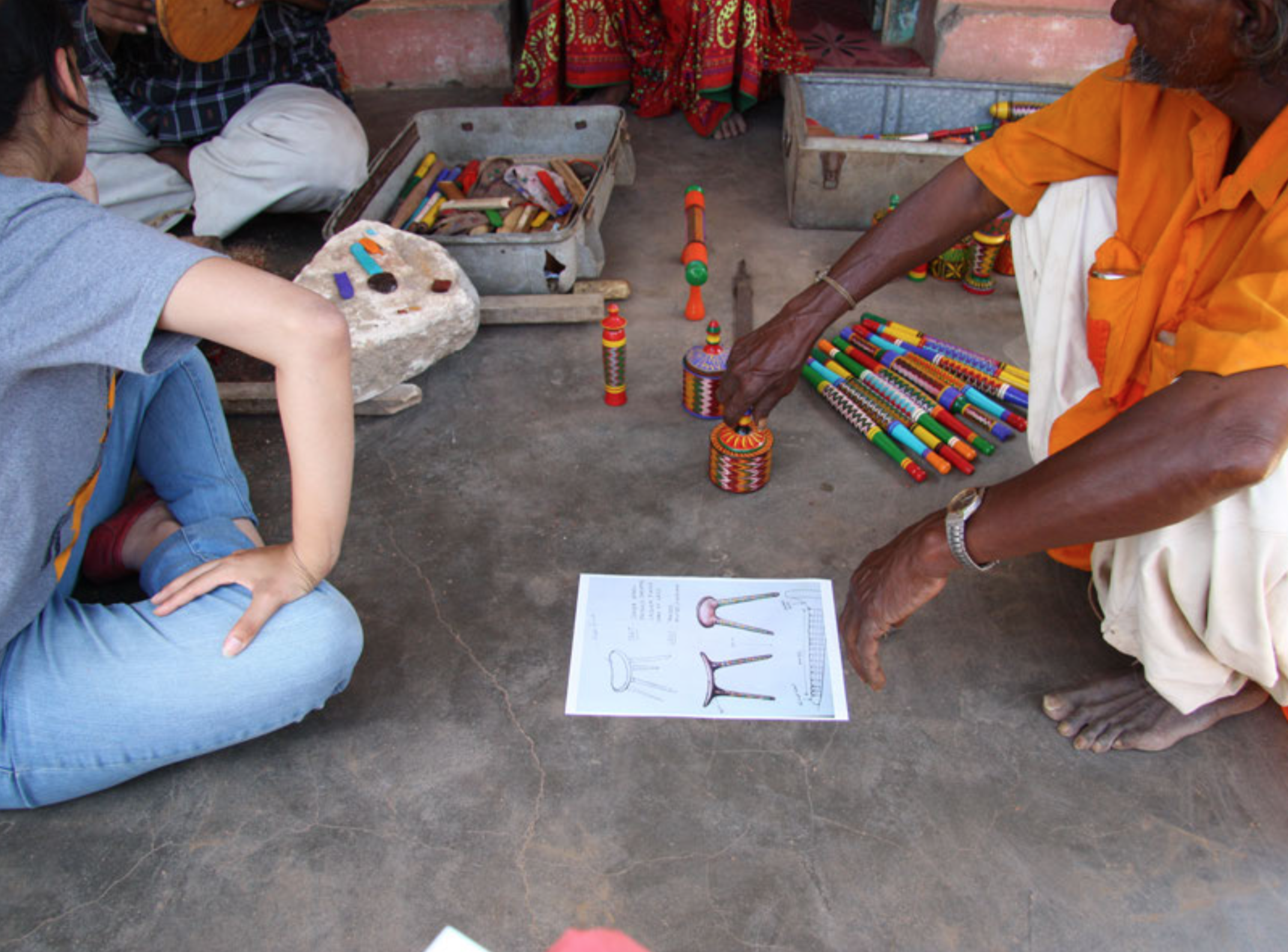 Craft worker reviews Matt Kavanagh's design for a foot stool as part of the Translocated Making research project, prior to him attempting to make it.
