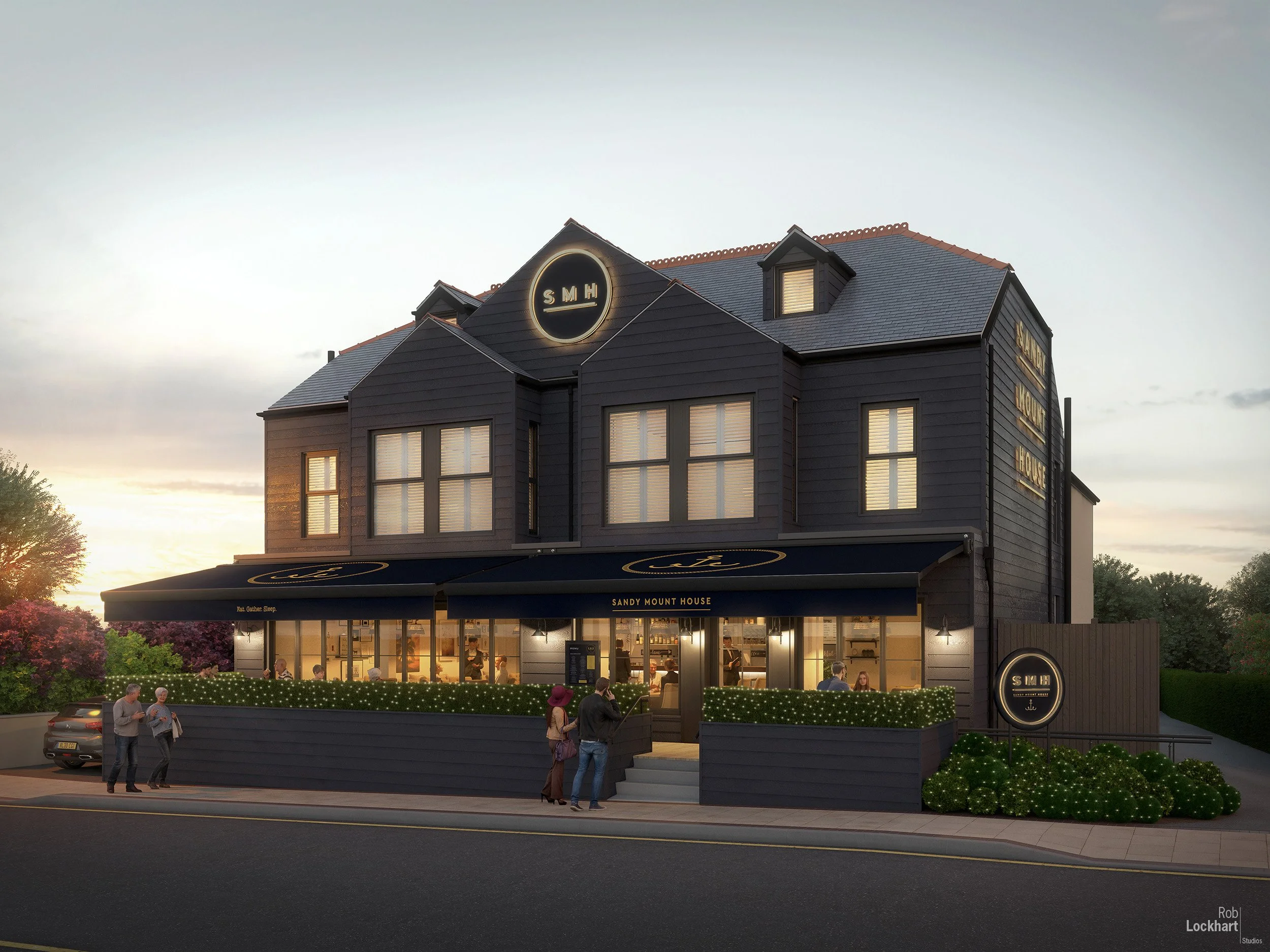 Exterior of a dark, three-story building with illuminated signs that reads 'Sandy Mount House' and 'SMH'. The porch area is lit and has people inside dining, with some people standing outside the entrance. The building has a mansard roof, dormer wind