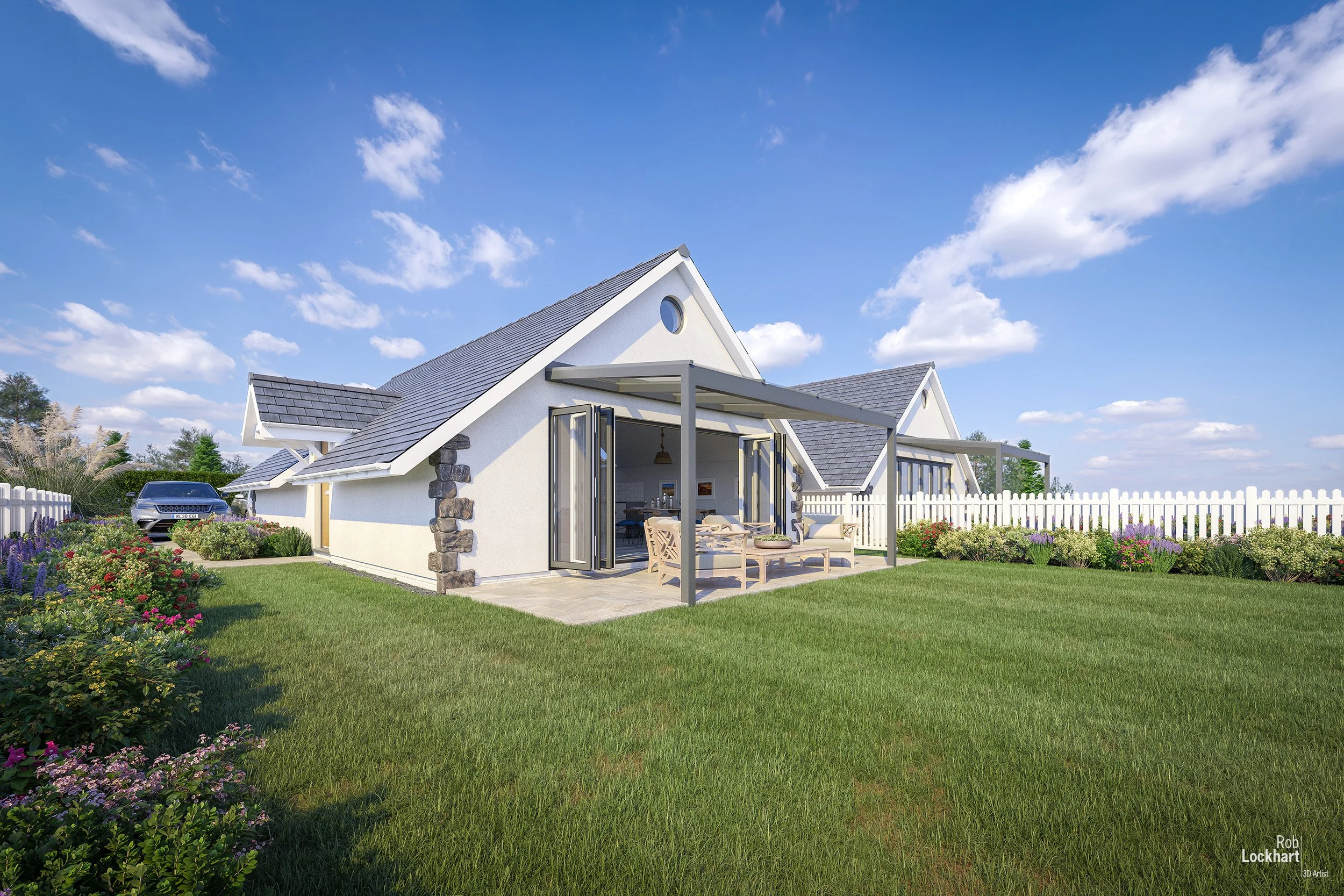 A modern white house with gray shingle roof, a patio with outdoor seating, a driveway with a car, surrounded by a green lawn and flower beds, enclosed by a white picket fence under a blue sky with scattered clouds.