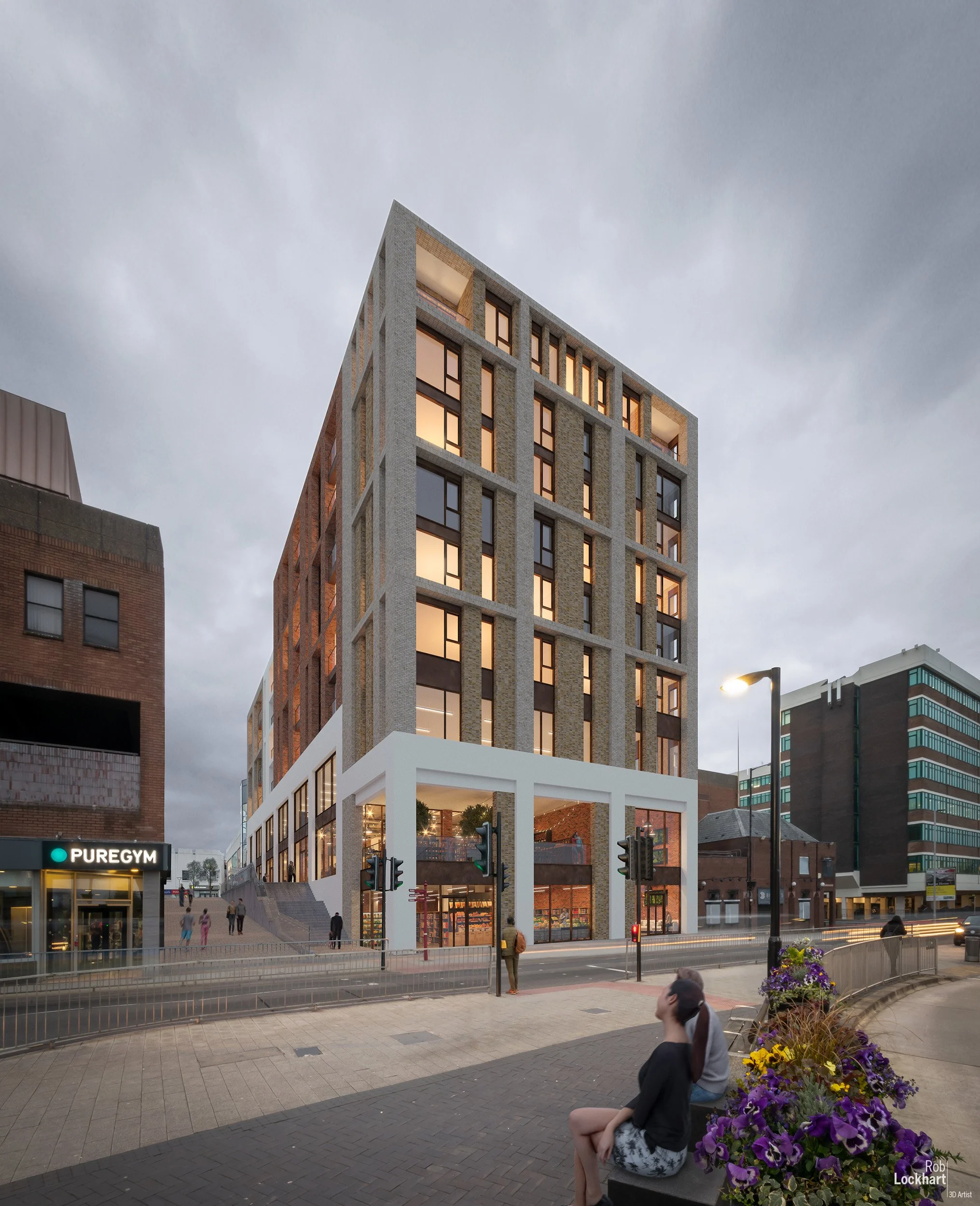 A modern multi-story building with large windows and a brick facade, situated on a city street at dusk. Pedestrians and people sitting nearby are visible.