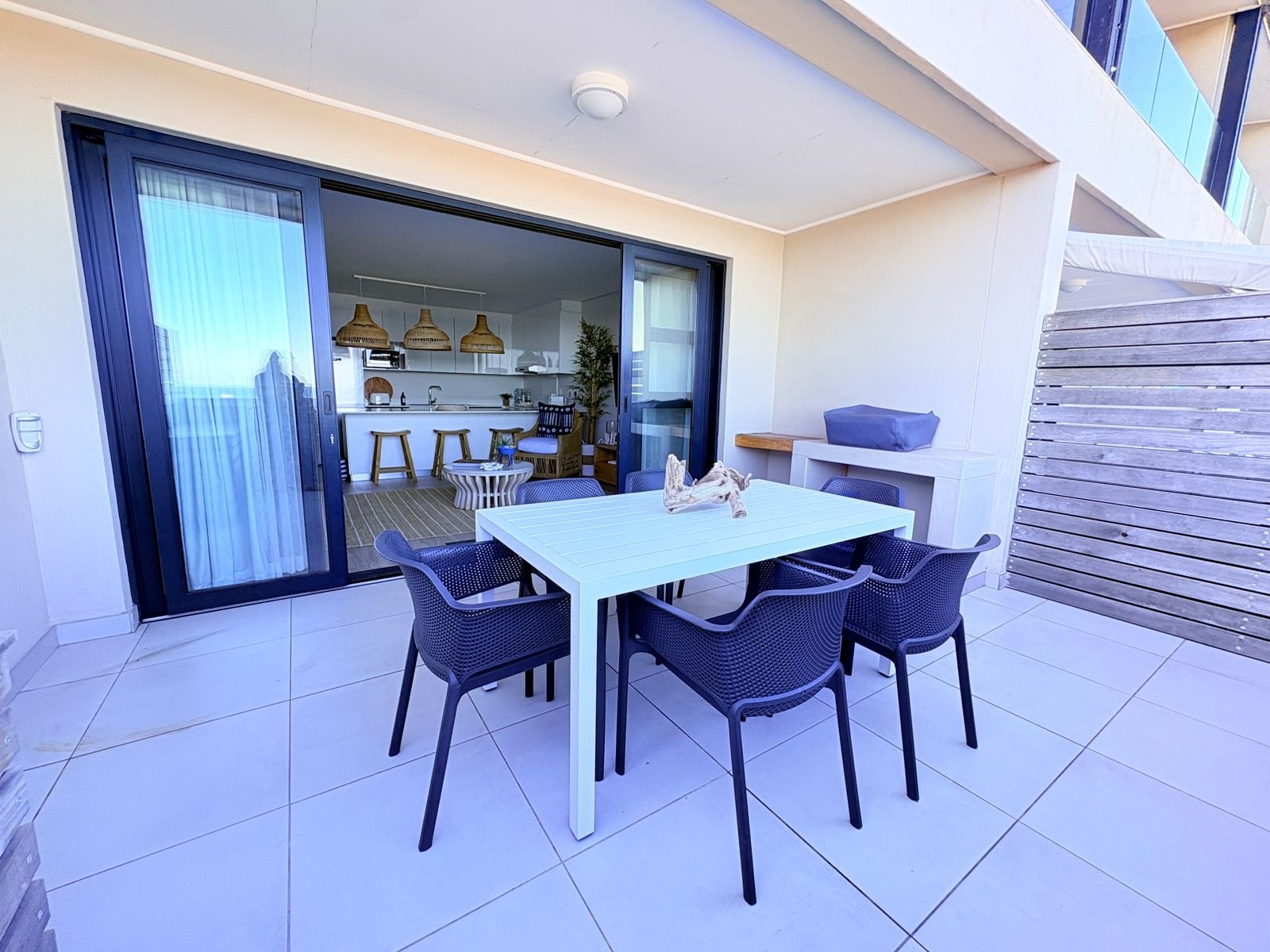 Large private patio with view of the ocean, a private BBQ and large outdoor dining table - The View, self-catering apartment