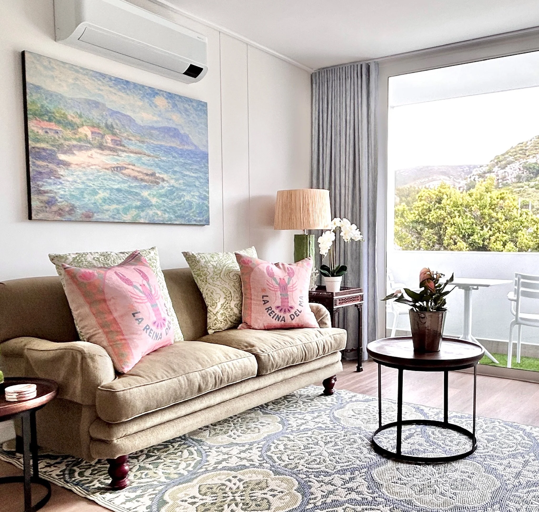 Living room with sofa and private balcony at Whale Walk apartment