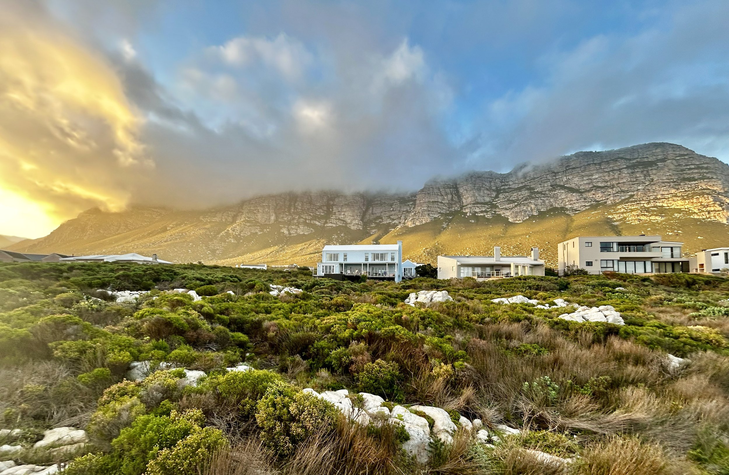 Aview of Misty Shores Cottage with the Mountain as a backdrop. The photo was taken from the coastline