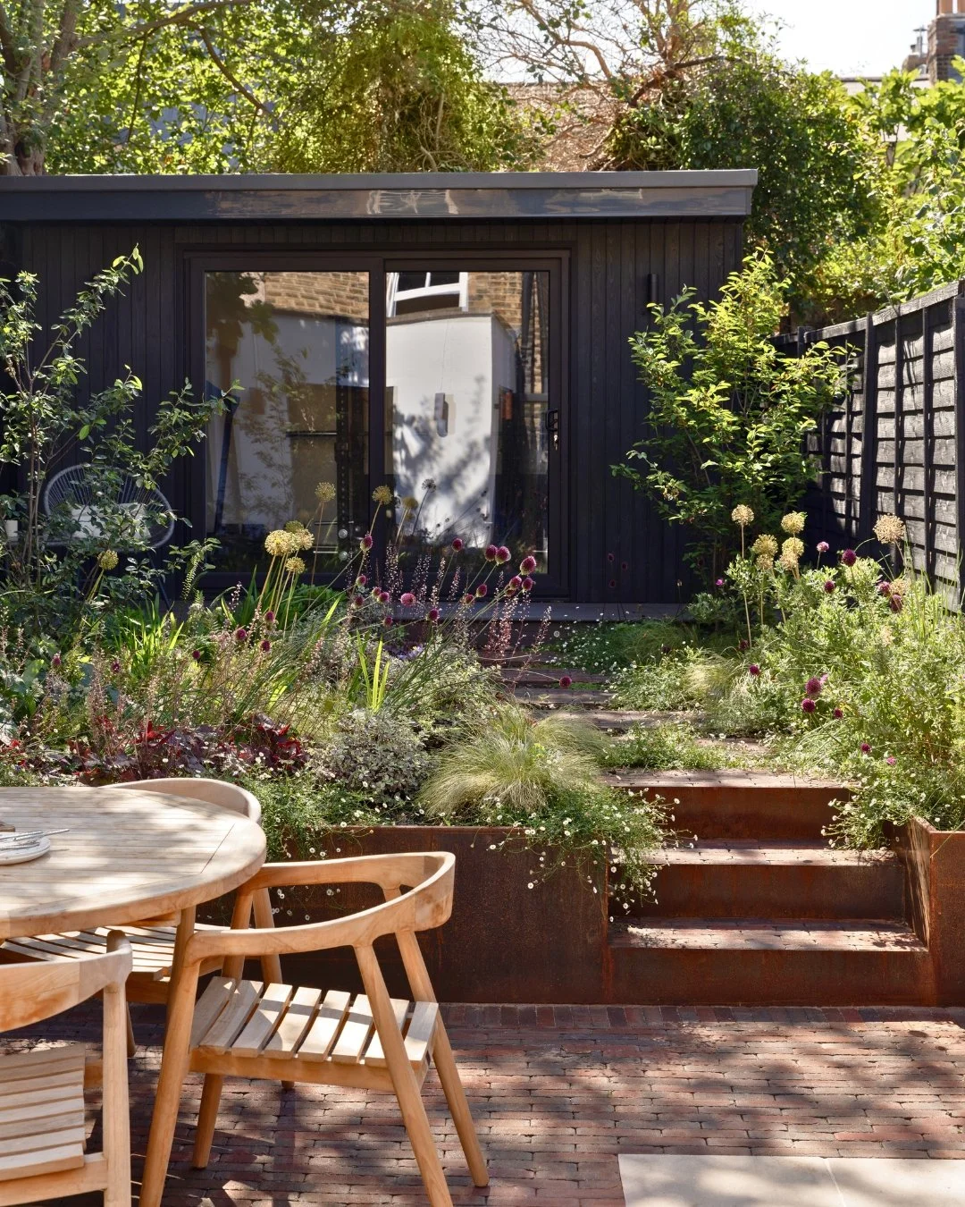 Some gardens reveal themselves slowly, and this Nunhead project is a lovely example.

Stretching over 20 metres from the back door to the very end of the garden, the journey moves past a new dining terrace and rebuilt retaining wall, before arriving 