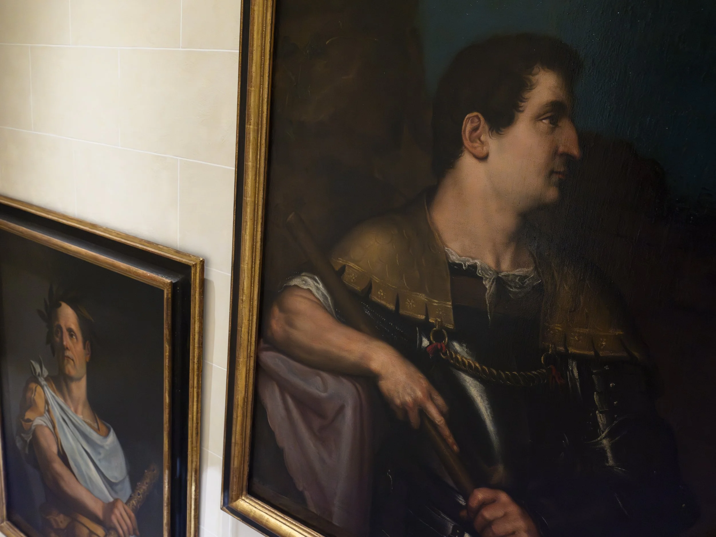 Painting of a man in a soldier's uniform with a dark background, exhibiting historical or classical portrait style.