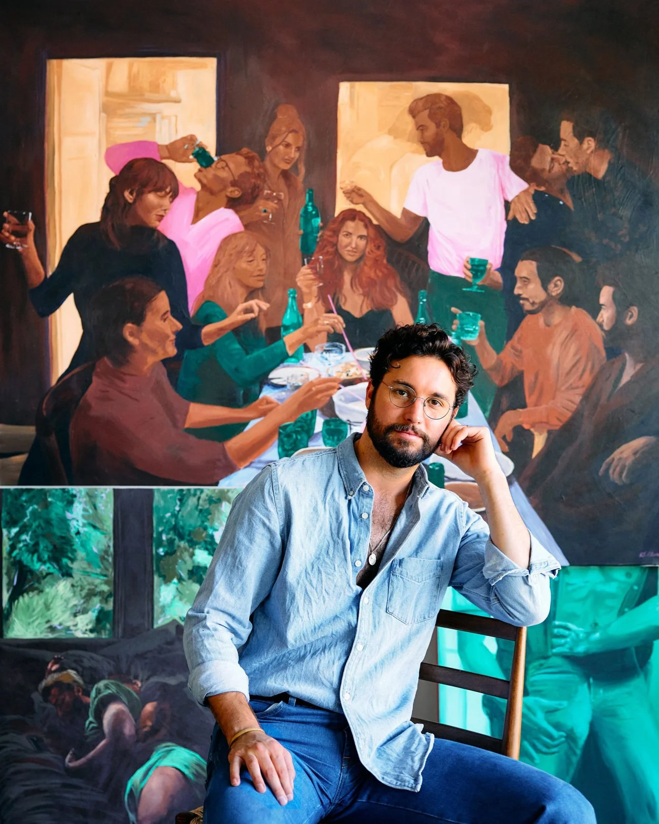 A man with glasses and a beard is sitting on a chair, resting his head on his hand, with a painting of a social gathering hanging on the wall behind him. The painting depicts a group of people seated around a long table, some standing and talking, with drinks and food on the table.