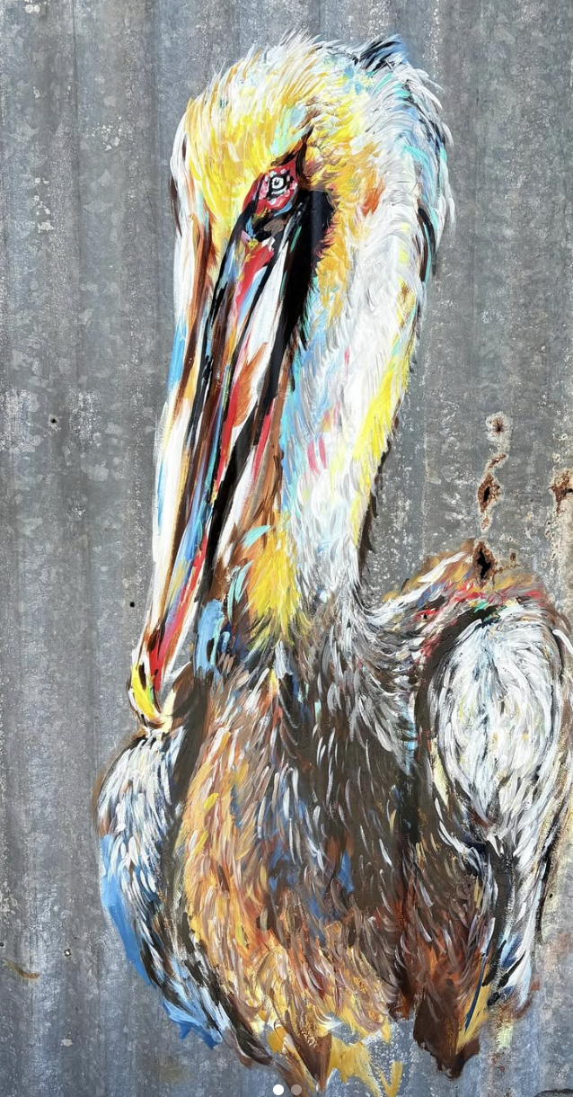Colorful painting of a pelican on a gray wall background.
