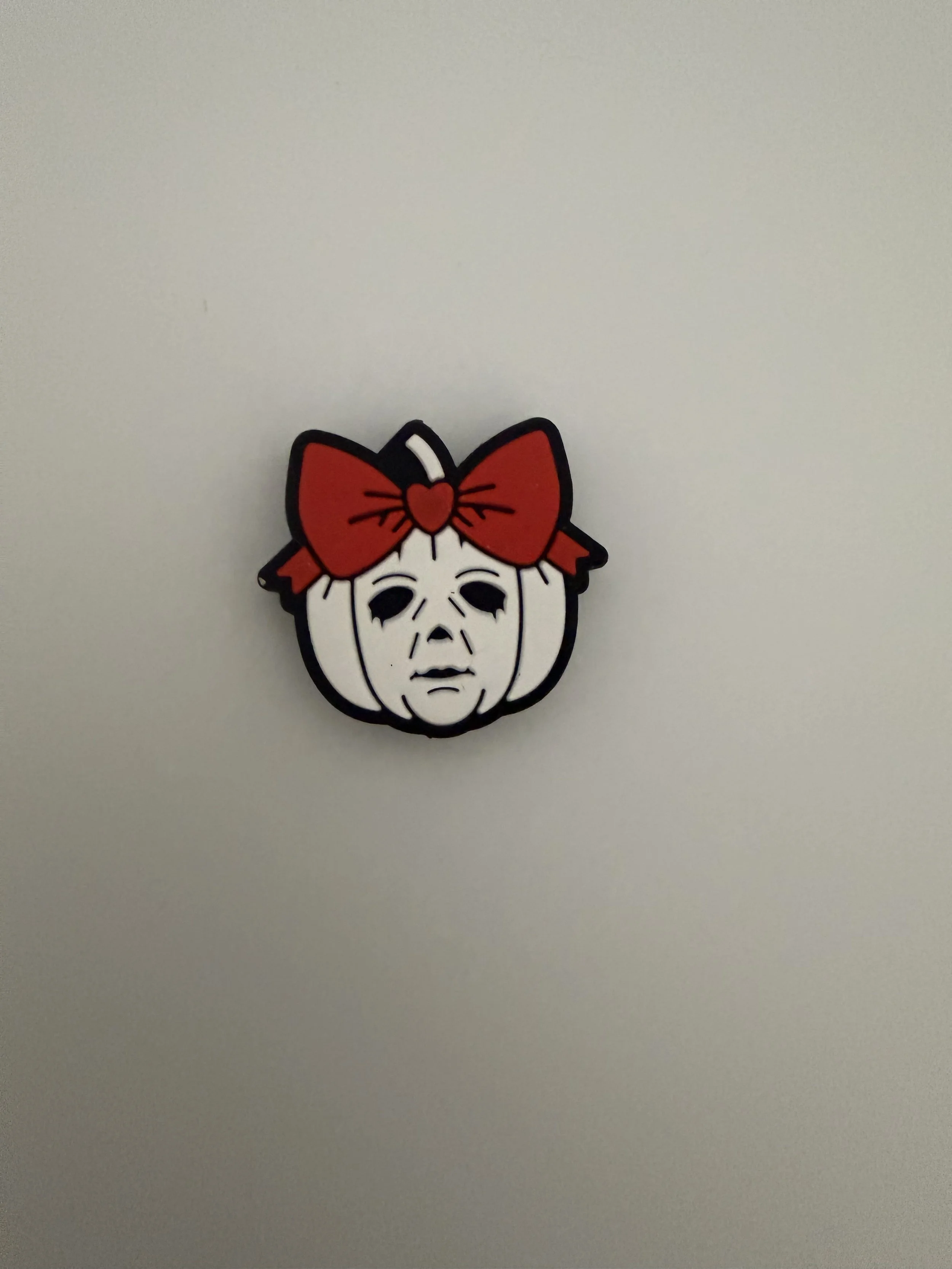 Pumpkin with face and red bow