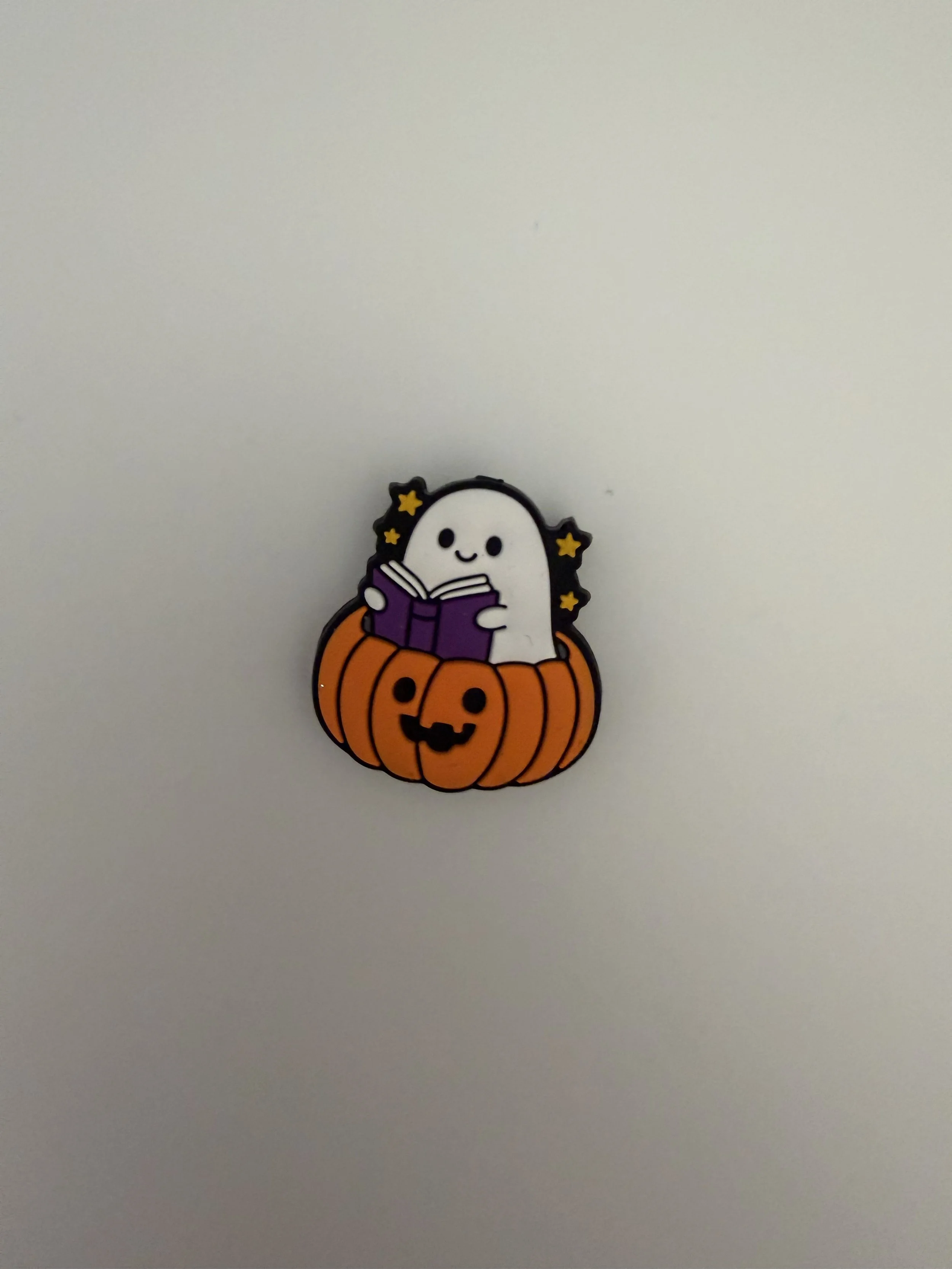 Ghost in pumpkin reading book
