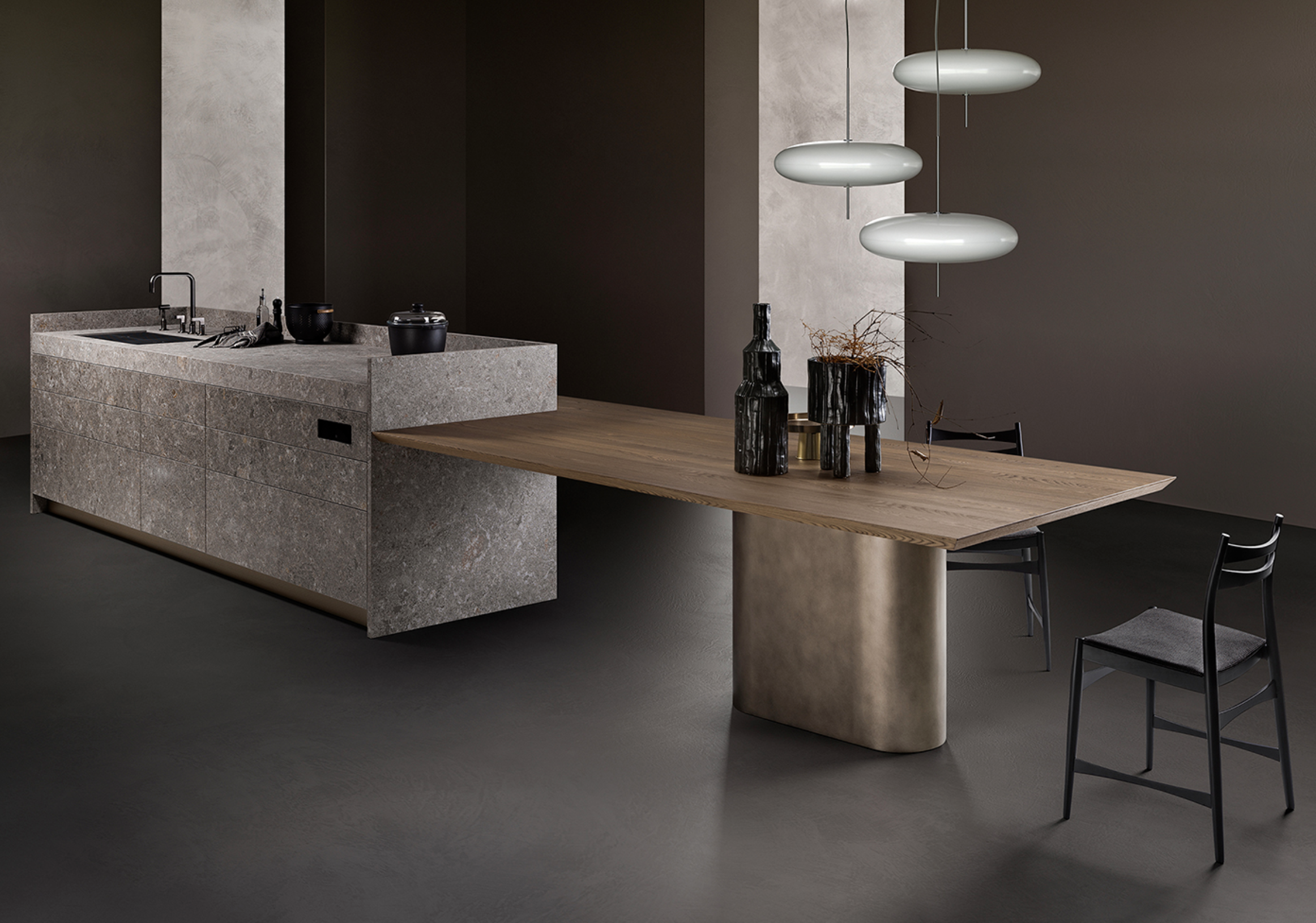 Modern kitchen with a stone and wood island and overlapping round pendant lights.