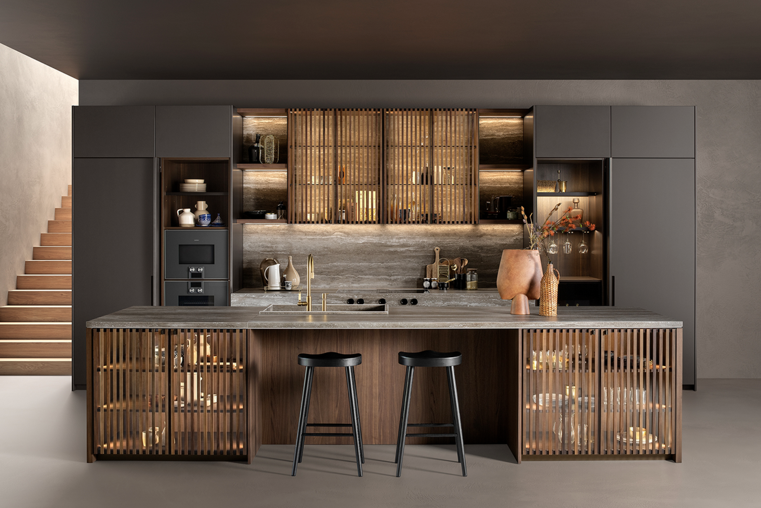 Modern kitchen with gray cabinets, a marble island with black stools, wooden accents, and decorative vases.