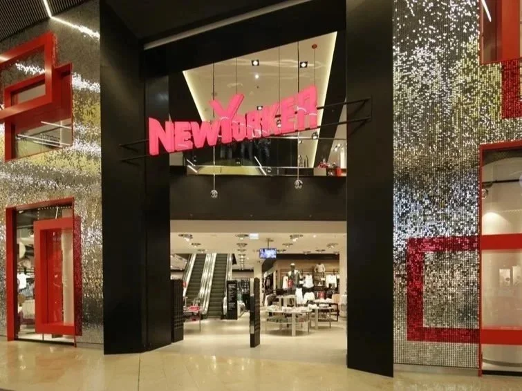 Eingang zu einem New Yorker Bekleidungsgeschäft im Einkaufszentrum mit leuchtendem pinkem Schriftzug