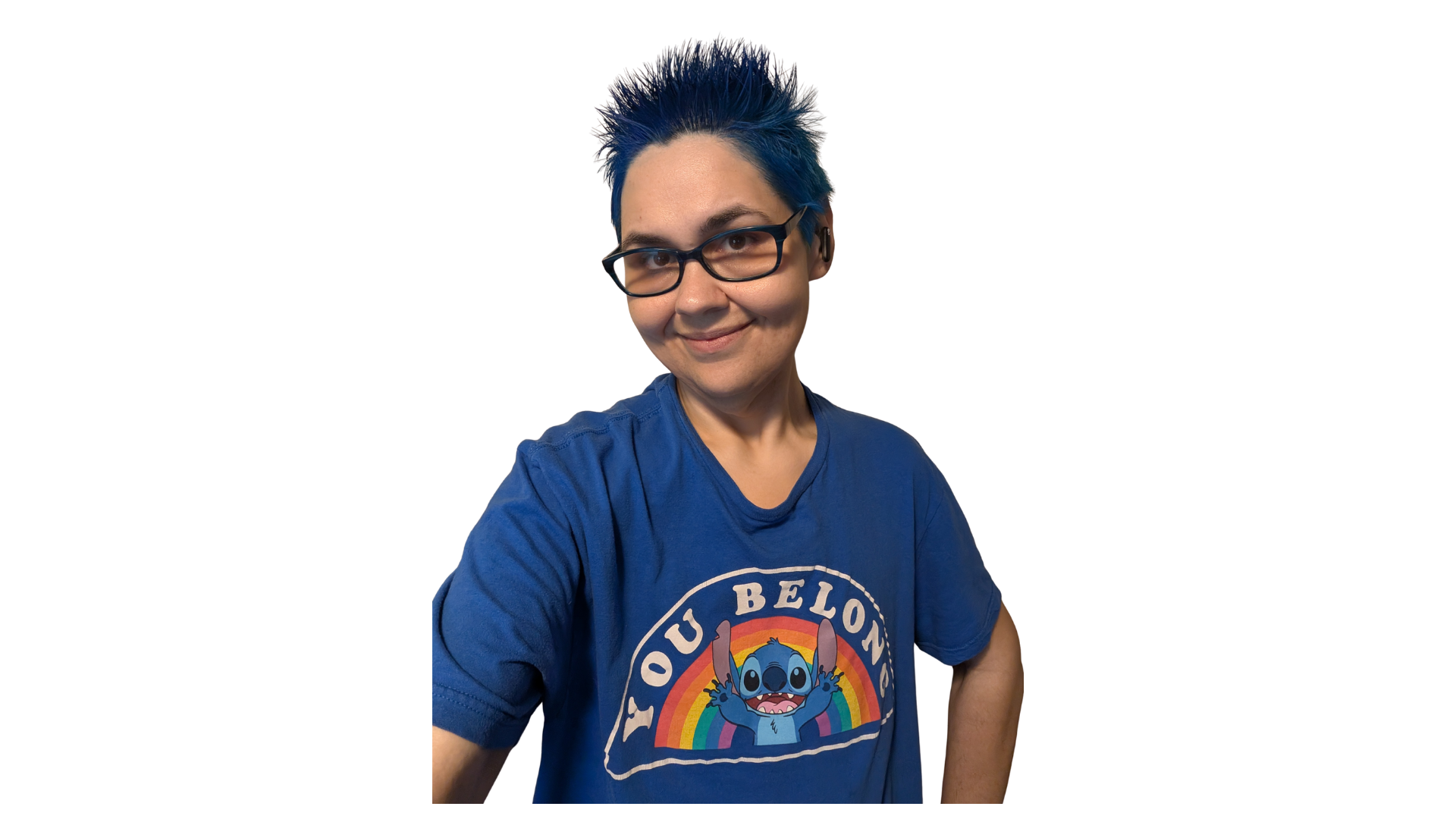 Person with blue spiked hair, glasses, wearing a blue t-shirt with a colorful cartoon character and rainbow design.