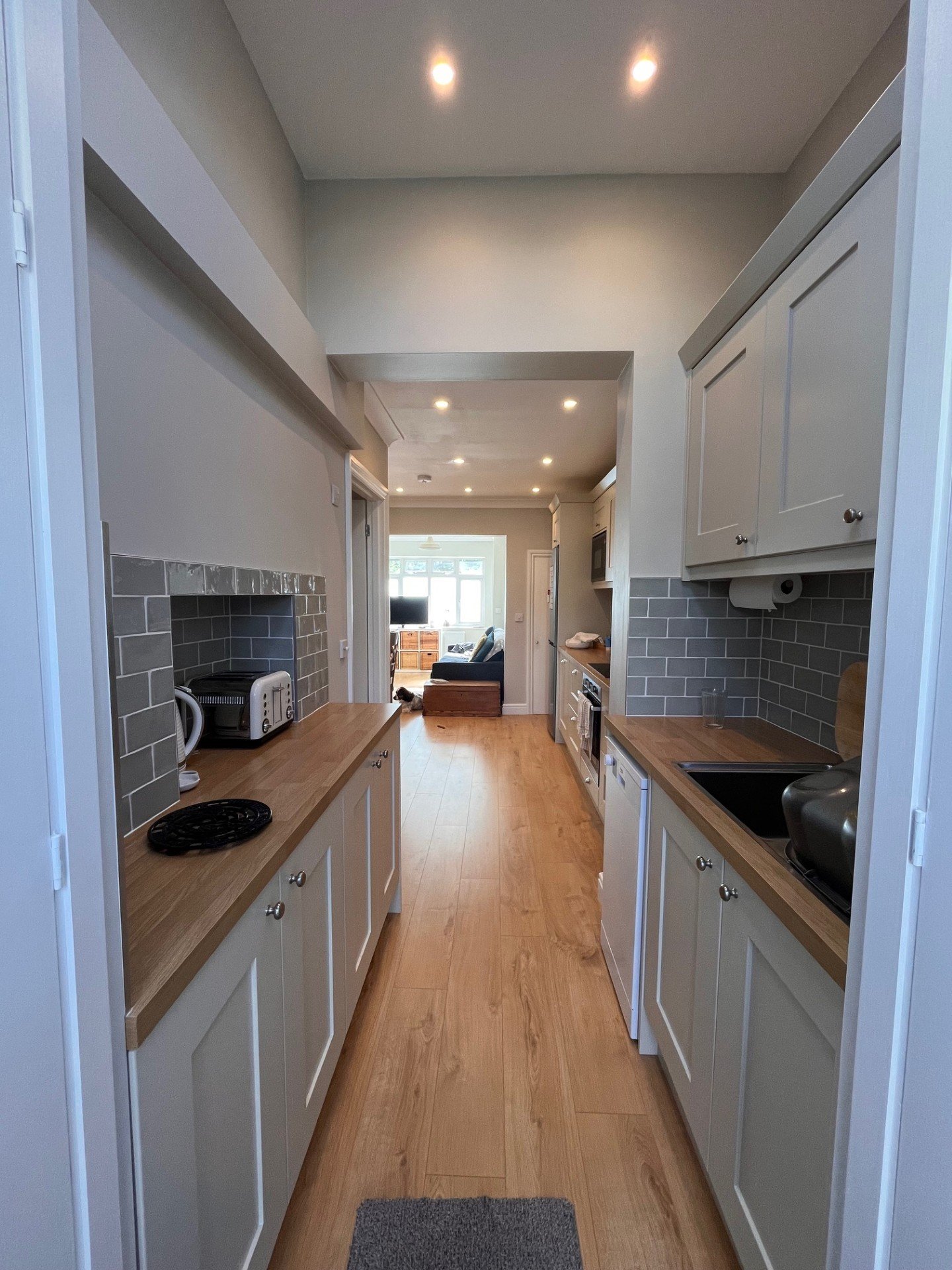 Custom Shaker-style galley kitchen installation with practical storage and modern finishes.