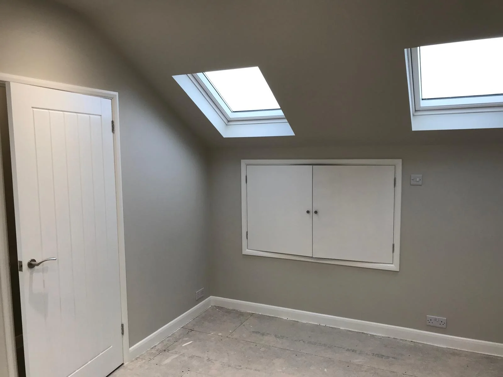 Renovated loft featuring new Velux windows, fresh plaster, and upgraded lighting to enhance space and functionality.